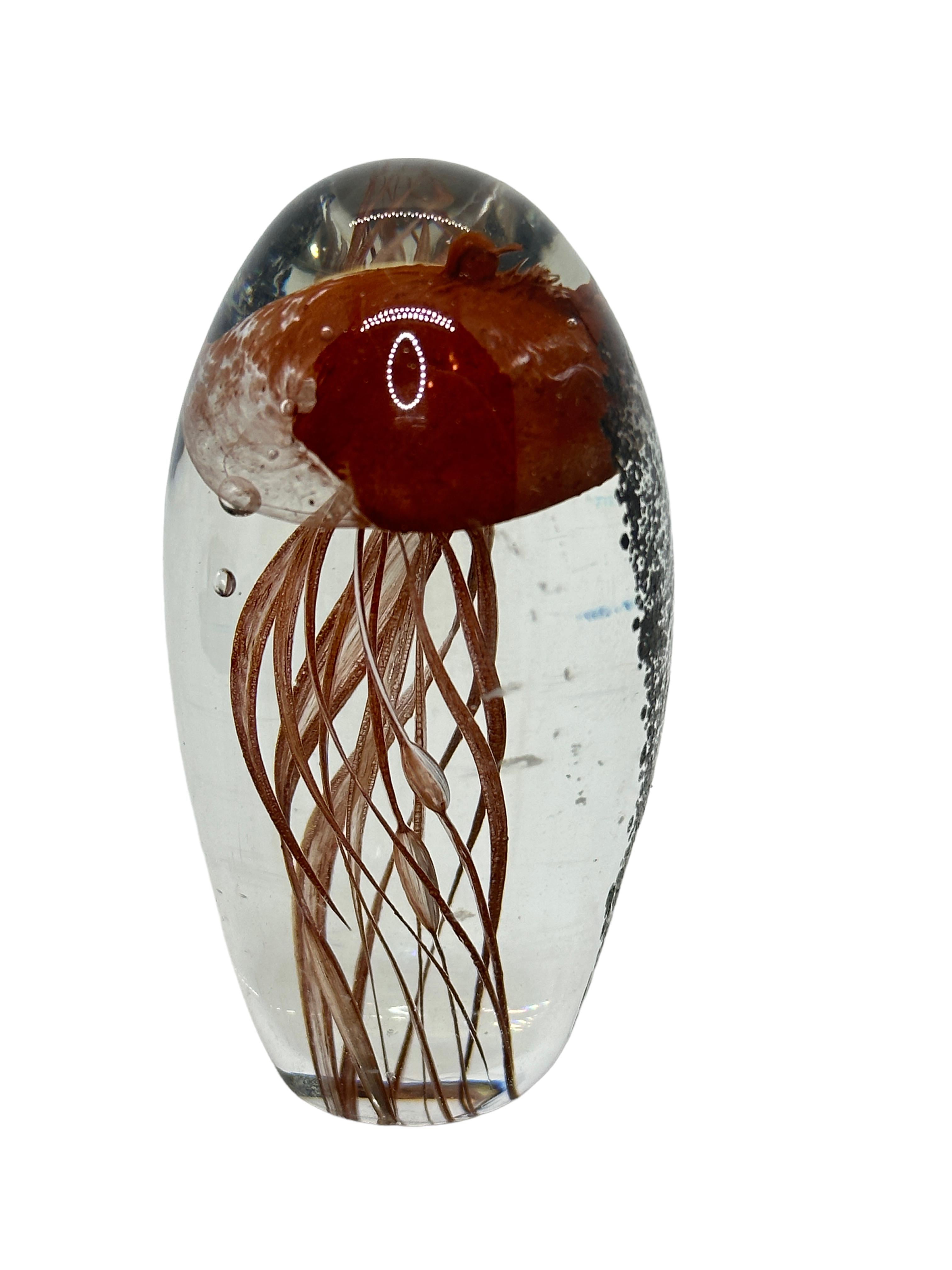 Beautiful Murano hand blown aquarium Italian art glass paper weight or sculpture. Showing a jellyfish, underwater floating on controlled bubbles in front of seaweed. Colors are a brown, white,  black and clear. A beautiful nice addition to your
