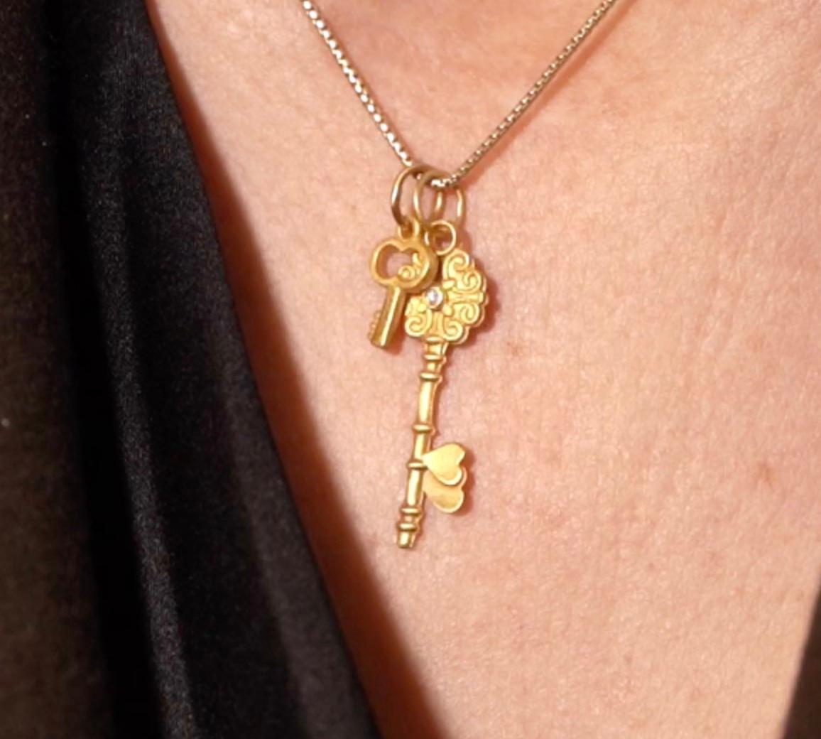 Miniature Key Charm Pendant Necklace, 24kt Solid Gold by Prehistoric Works of Istanbul, Turkey. This key charm pairs well alone or with other coin amulet or charms.  Measures 8mm x 13mm. Comes with a 16