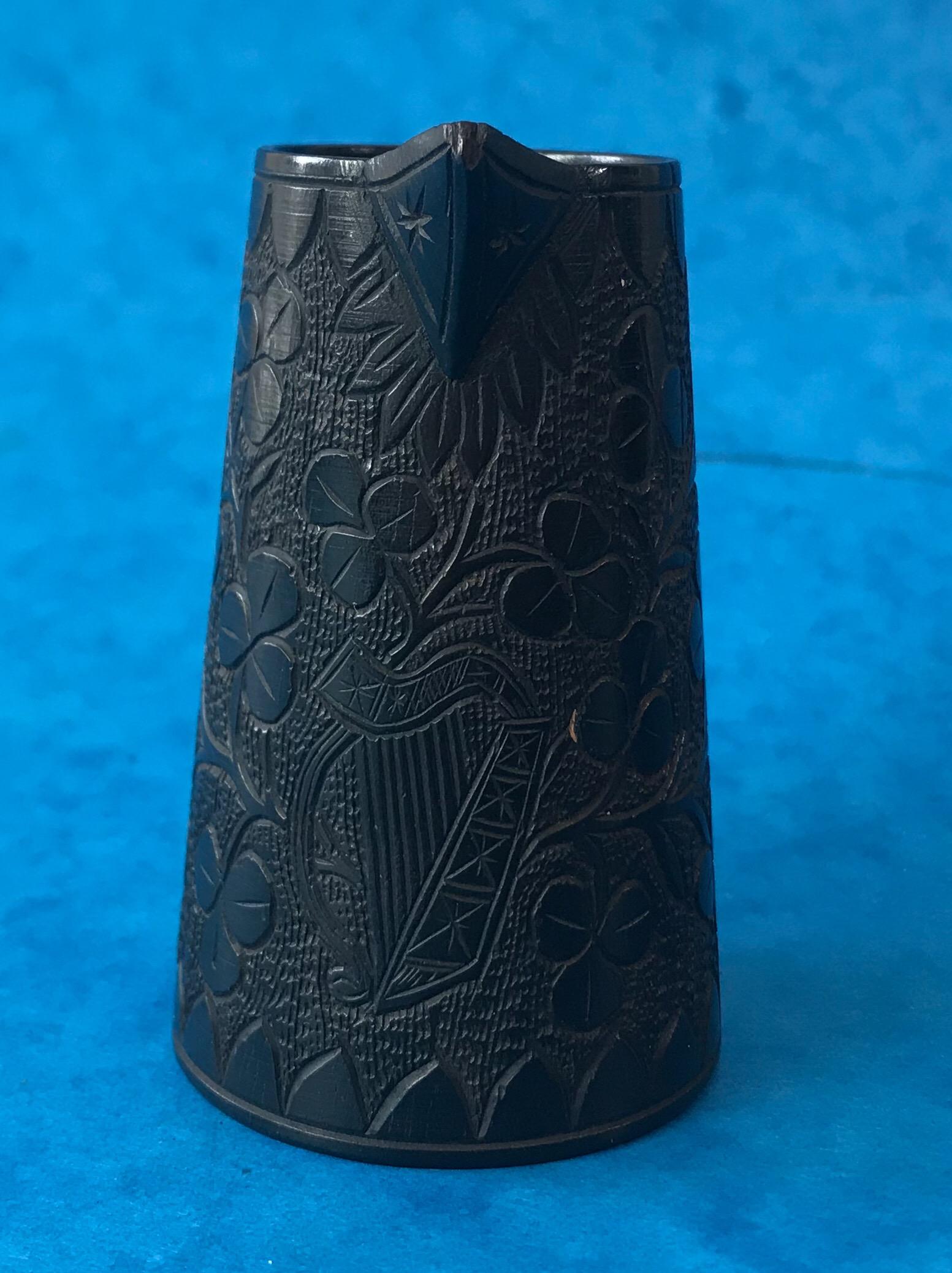 A miniature Killarney ware jug, the jug is Irish and dates back to 1870. It’s made of bog oak it has wonderful patterned leafs and a harp around the jug, it’s in superb condition.
The jug measures 5 by 4.5 and stands 8 cm high.