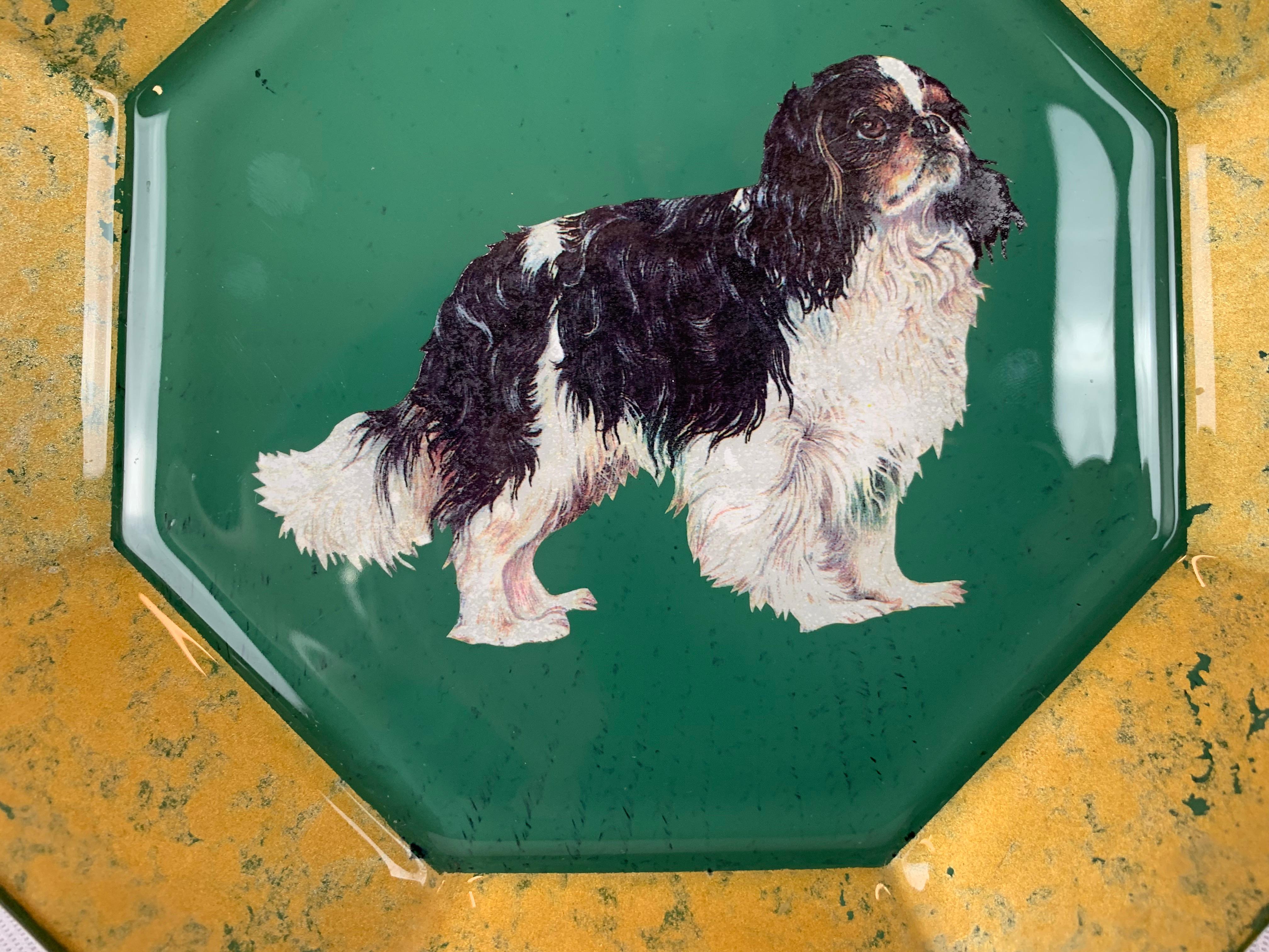 Portrait plate of a miniature tri-color King Charles Spaniel. The artisan used an octagonal shaped French glass plate and applied the dog's image to the back and then overpainted it with greens and golds. Hand written on the back is the following