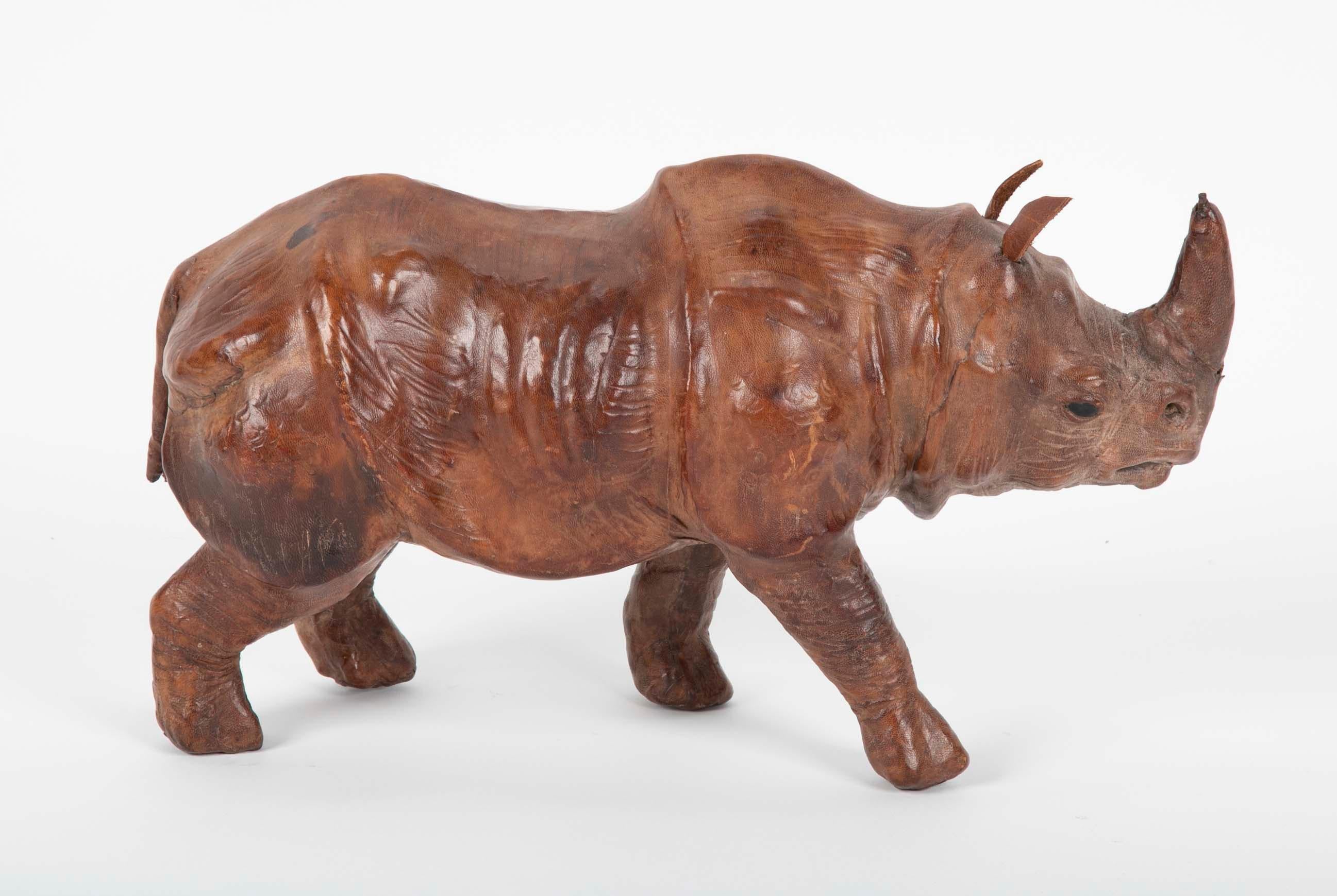 An very detailed leather clad model of a rhinoceros. With glass eyes and realistic features, a miniature version of a live rhino. The leather work is amazing.