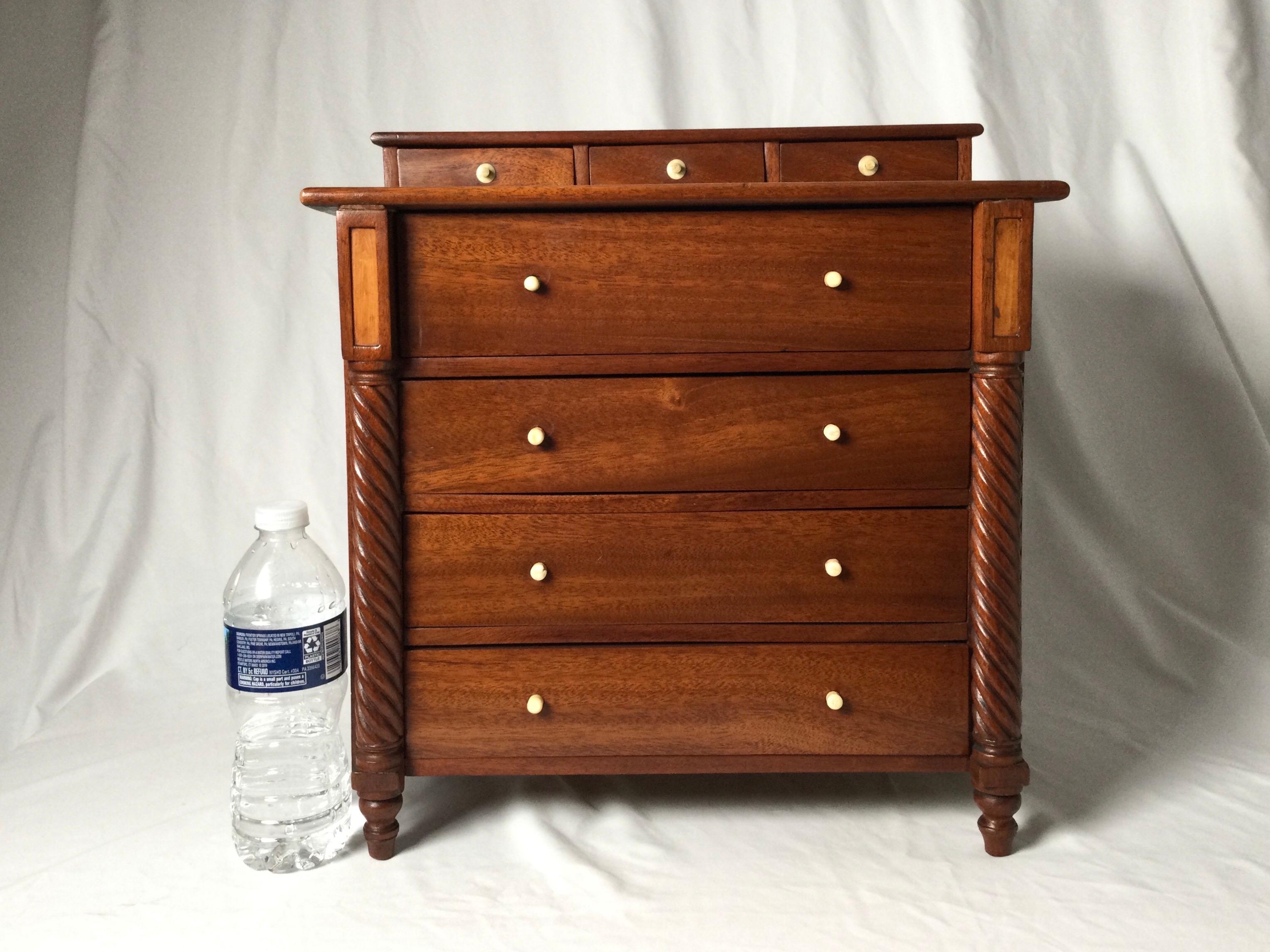 Miniature mahogany four-drawer Sheraton chest with rope turned front legs. Measures: 16