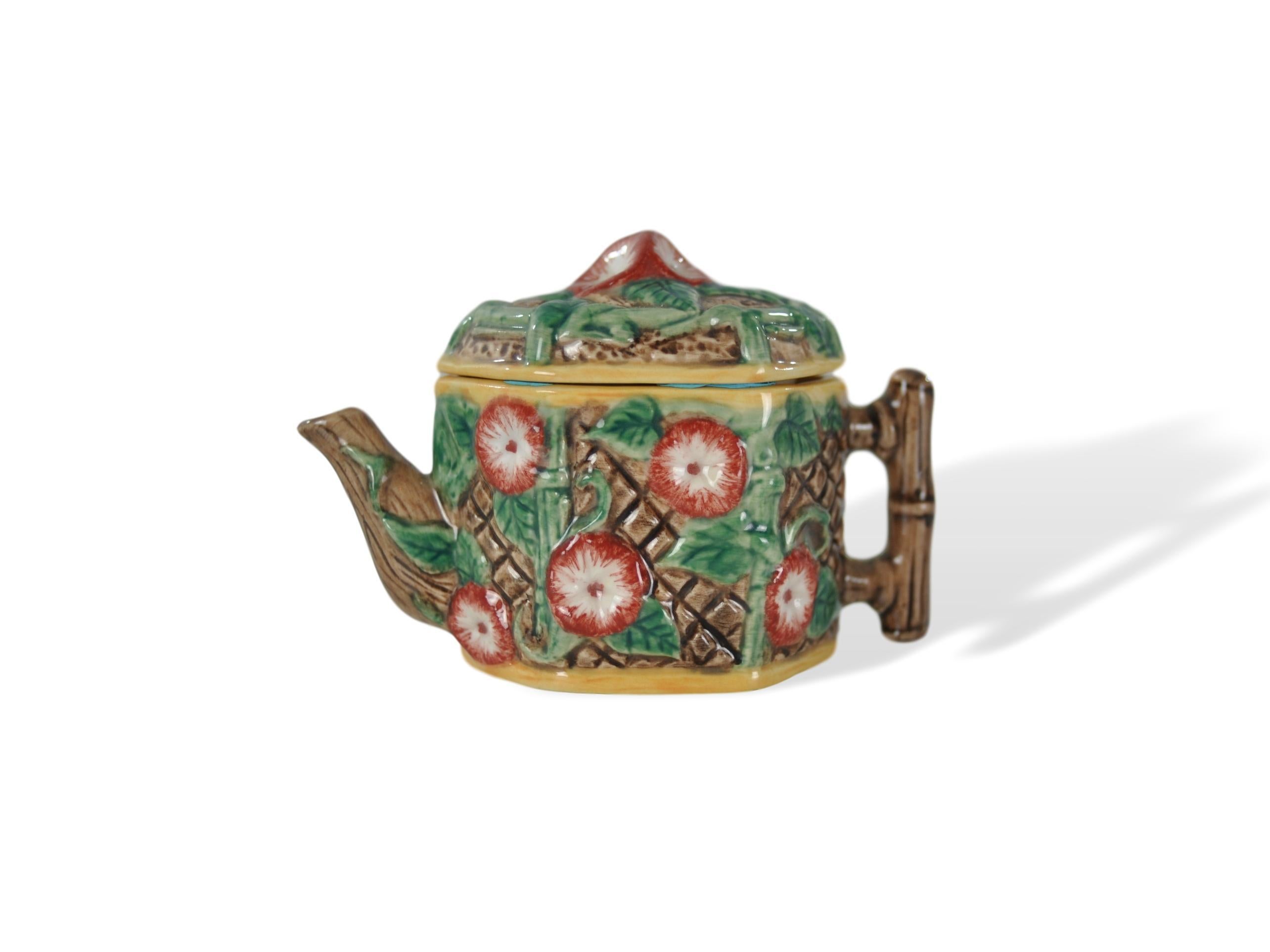 Miniature Majolica-glazed teapot, on a porcelain body, English, morning glories on trellis, English, circa 1920. This charming little piece is of extremely high quality; it is molded and glazed beautifully.
In excellent condition.