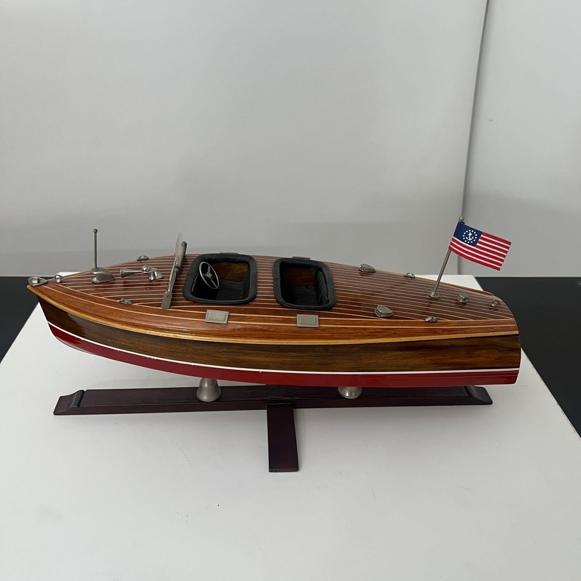 Large, very decorative and detailed model of a two-seater wooden motorboat in the style of the runabout or barrel back boats by Chris-Craft (USA).
Worked in various woods, including mahogany, teak and maple, partly stained and inlaid. Underside
