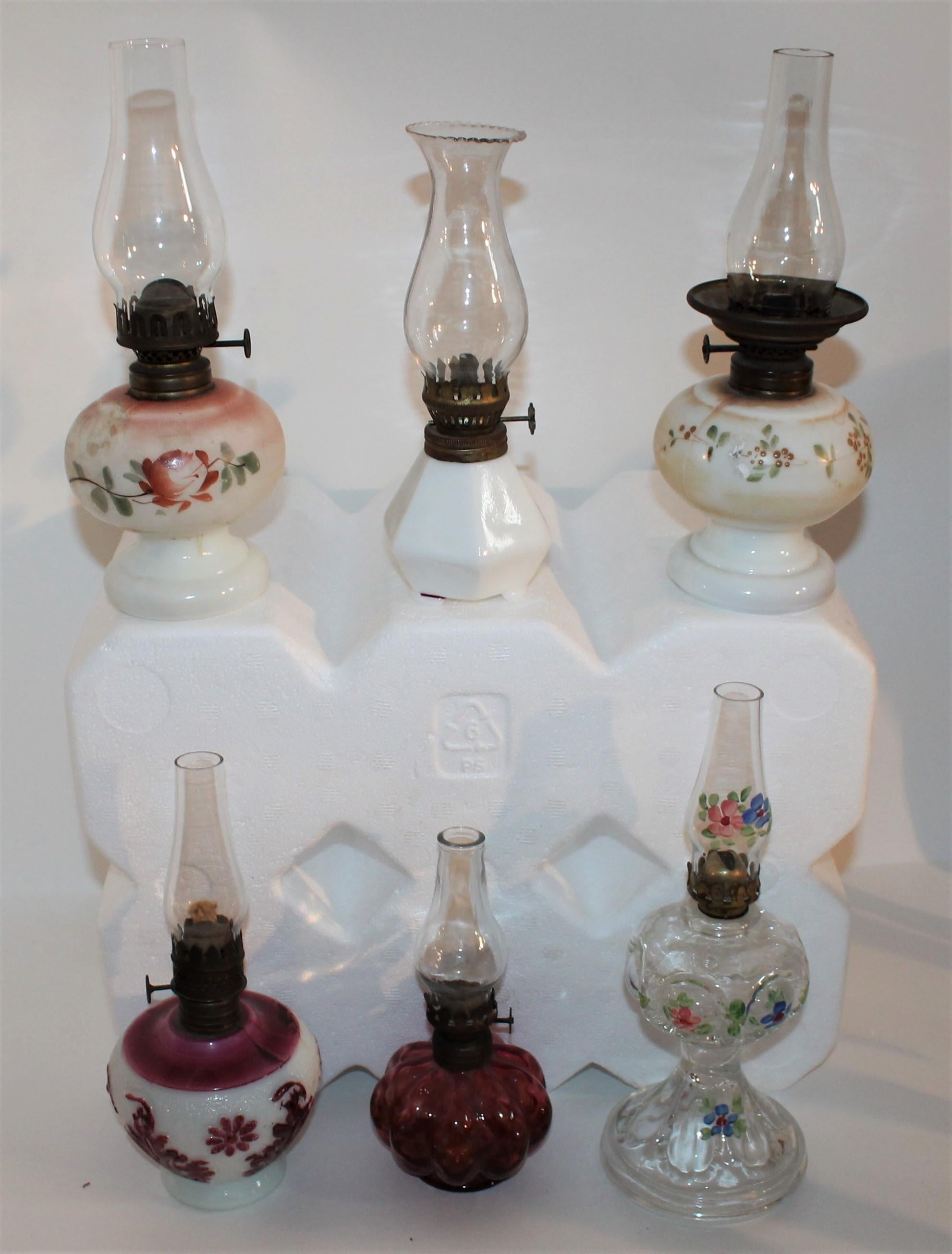 Collection of 19th century original painted glass and milk glass miniature oil lamps. Sold as a collection of six.

Largest gas light measures- 3.5 inches in diameter and 9 inches in height with bulb.
Smallest gas light measures-3 inches in