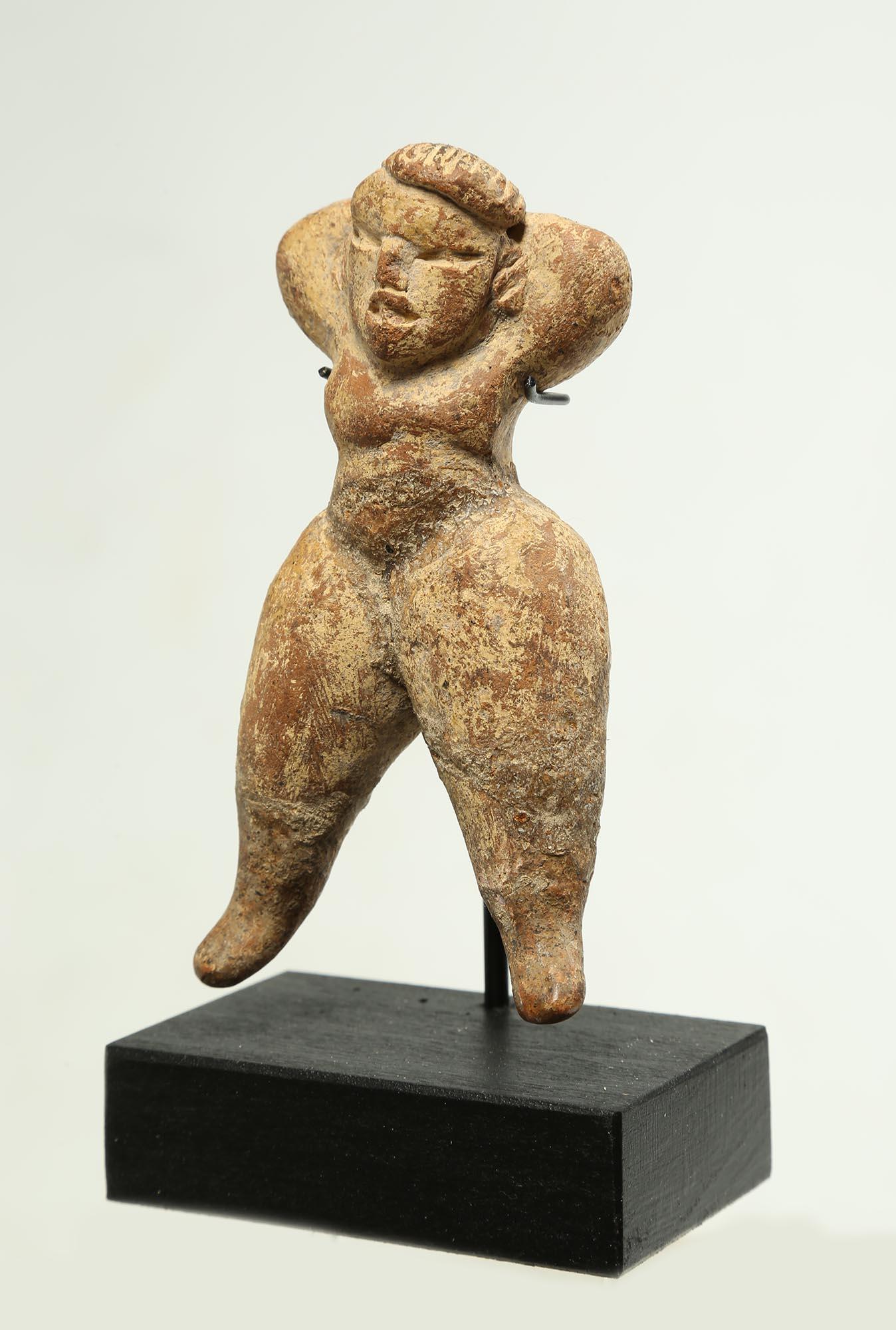 Delightful miniature Olmec standing female figure with hands on head, Pre-Columbian Mexico. Well-modeled legs similar to Tlatilco 