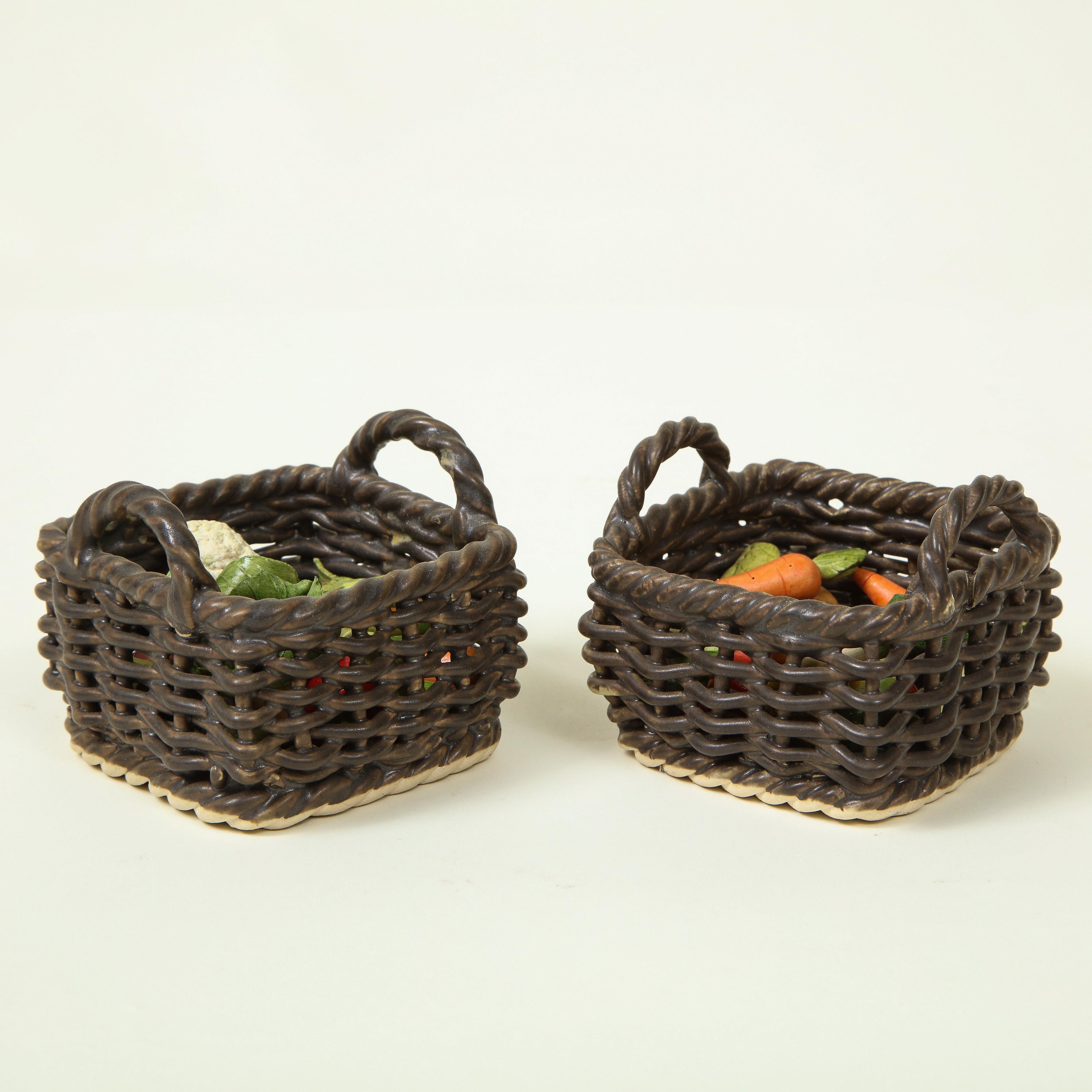 Each finely modeled as a brown two-handled wicker basket filled with hand-painted vegetables including carrots, cauliflower, and endives.
 