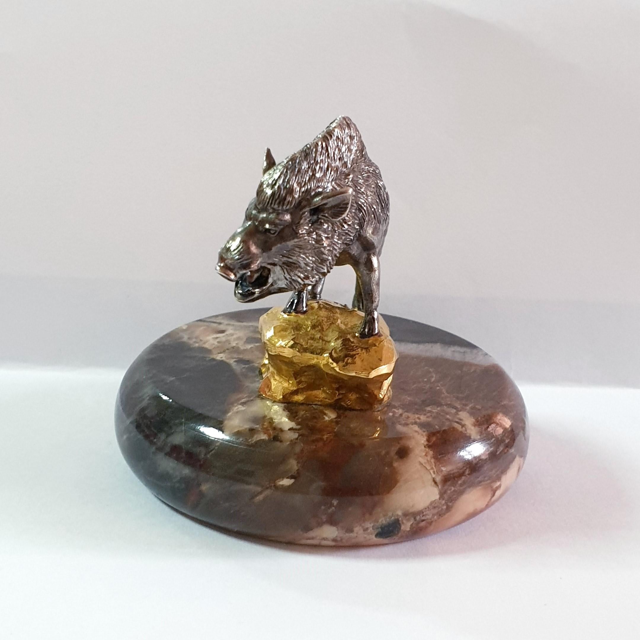 A pig, a symbol of fertility and abundance, was made into a silver miniature with a creative idea and masterful craftsmanship. A genuine silver wild pig has lively facial features and a brave posture. He stands proudly on a golden rock mountain,