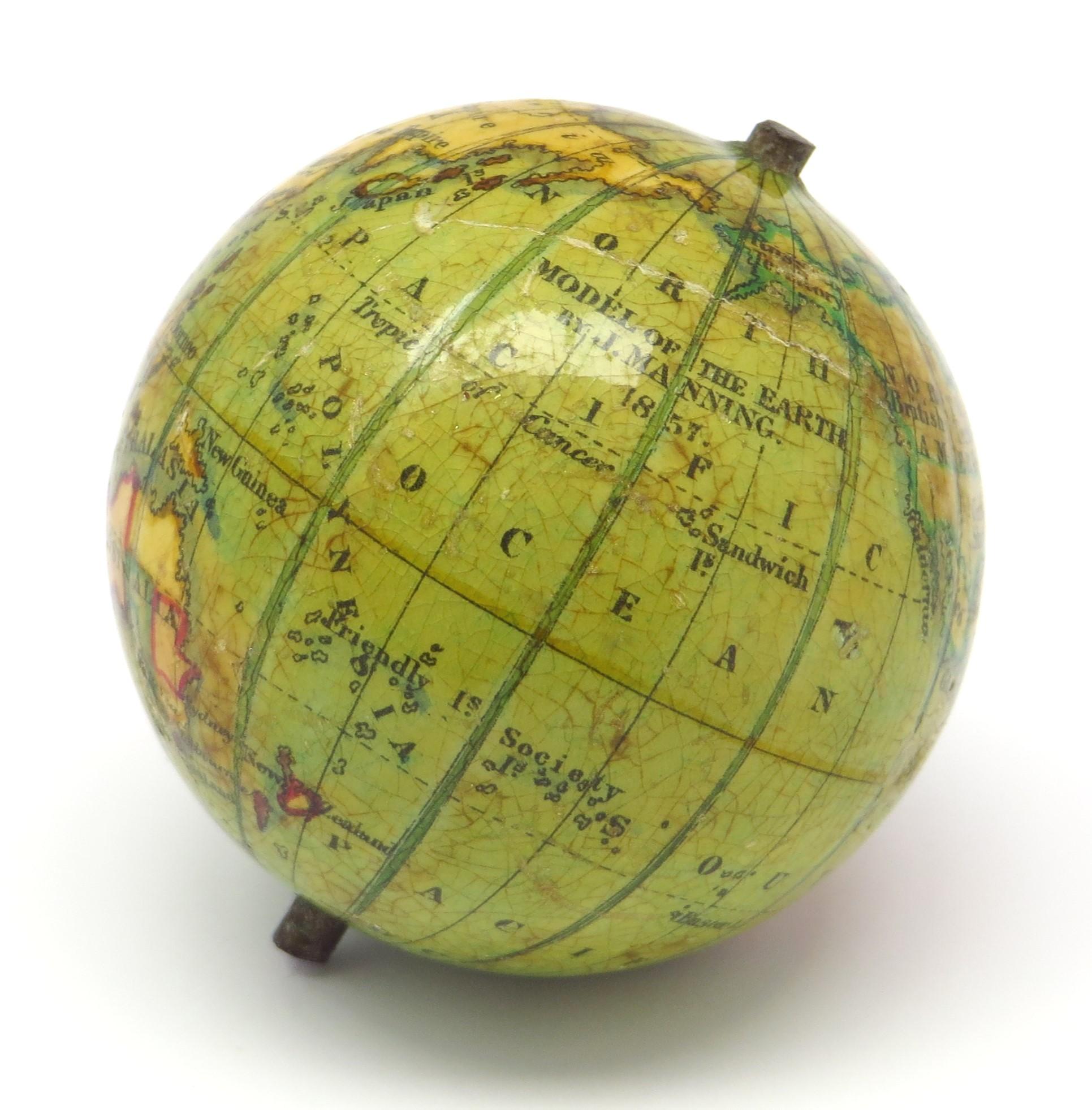 Miniature terrestrial pocket globe. Model of the earth.

London, 1857 by J. Manning
diameter of 1,75 inches / 4,5 cm.

This lovely miniature terrestrial globe consists of twelve copper engraved, hand coloured gores over a wooden base. The gores are