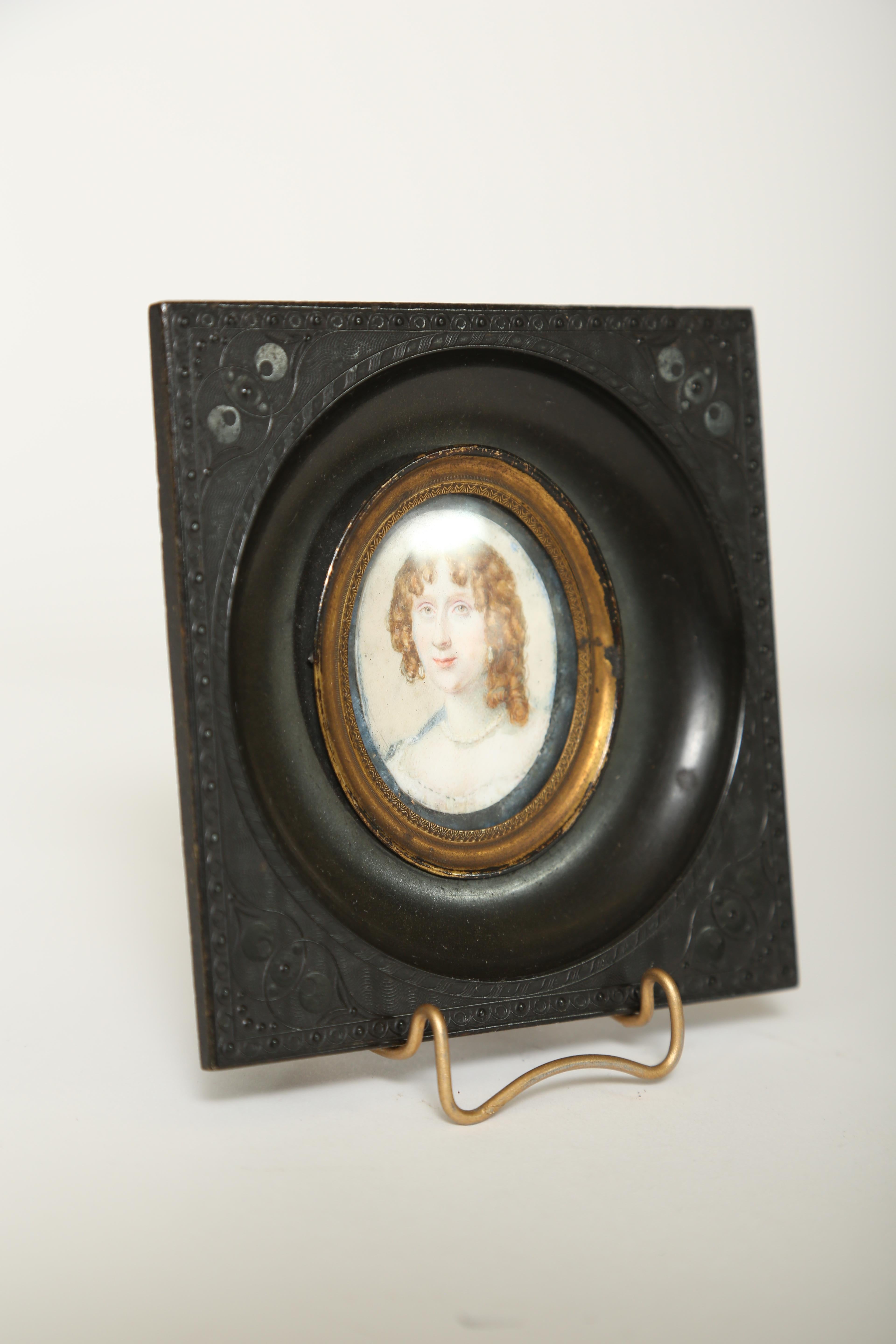 Miniature portrait of a lady delicately hand painted on ivory in an engine turned style gutta-percha frame. On the back the original hand forged iron loop remains intact.

(This item is eligible for a gift box)