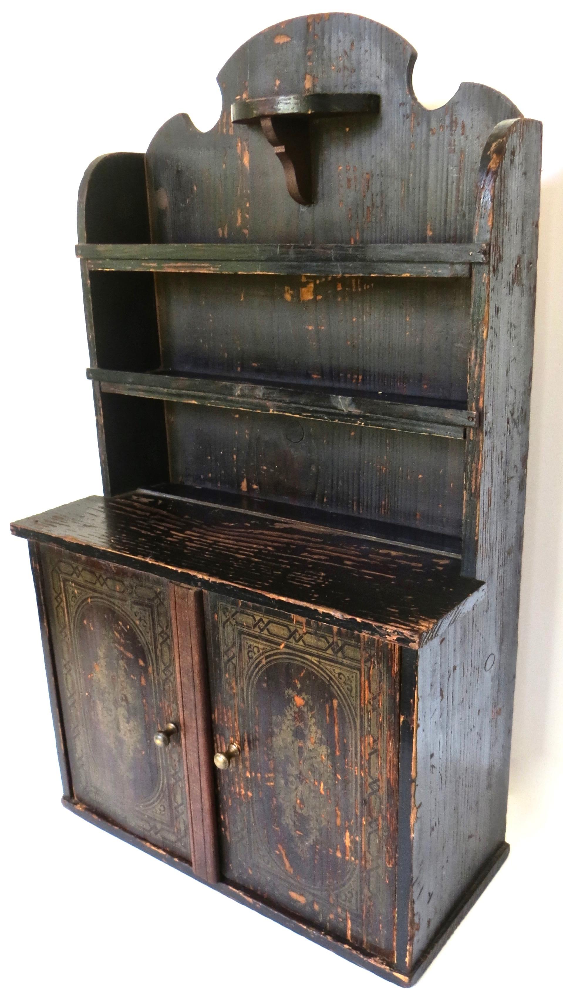 This mid 19th century miniature two door cupboard with step back 