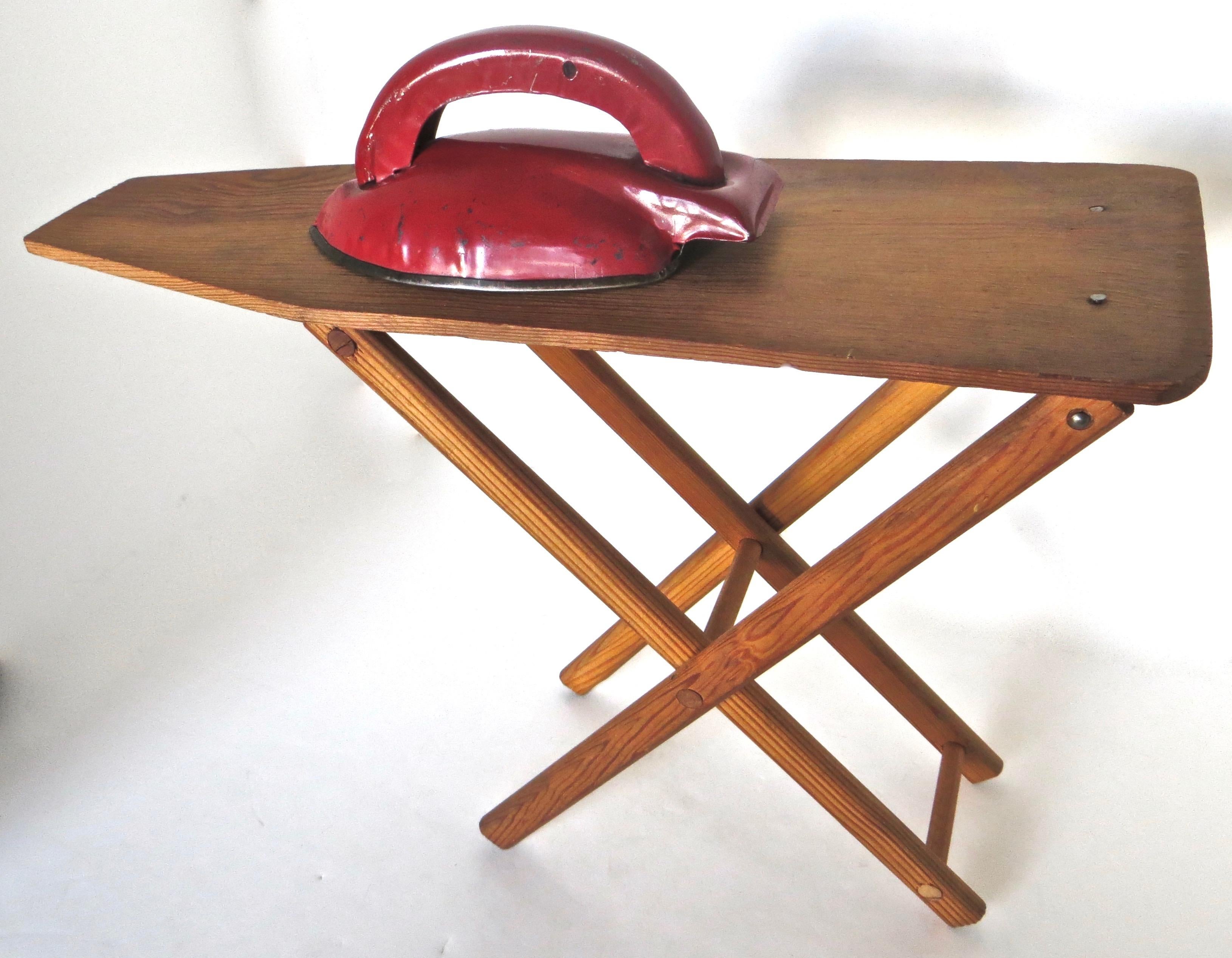 Salesman sample circa 1920 miniature ironing board accompanied by a hand painted metal iron, are both handmade and in excellent all original condition with no repairs; the iron is in it's copious original bright red paint with no touch up.
