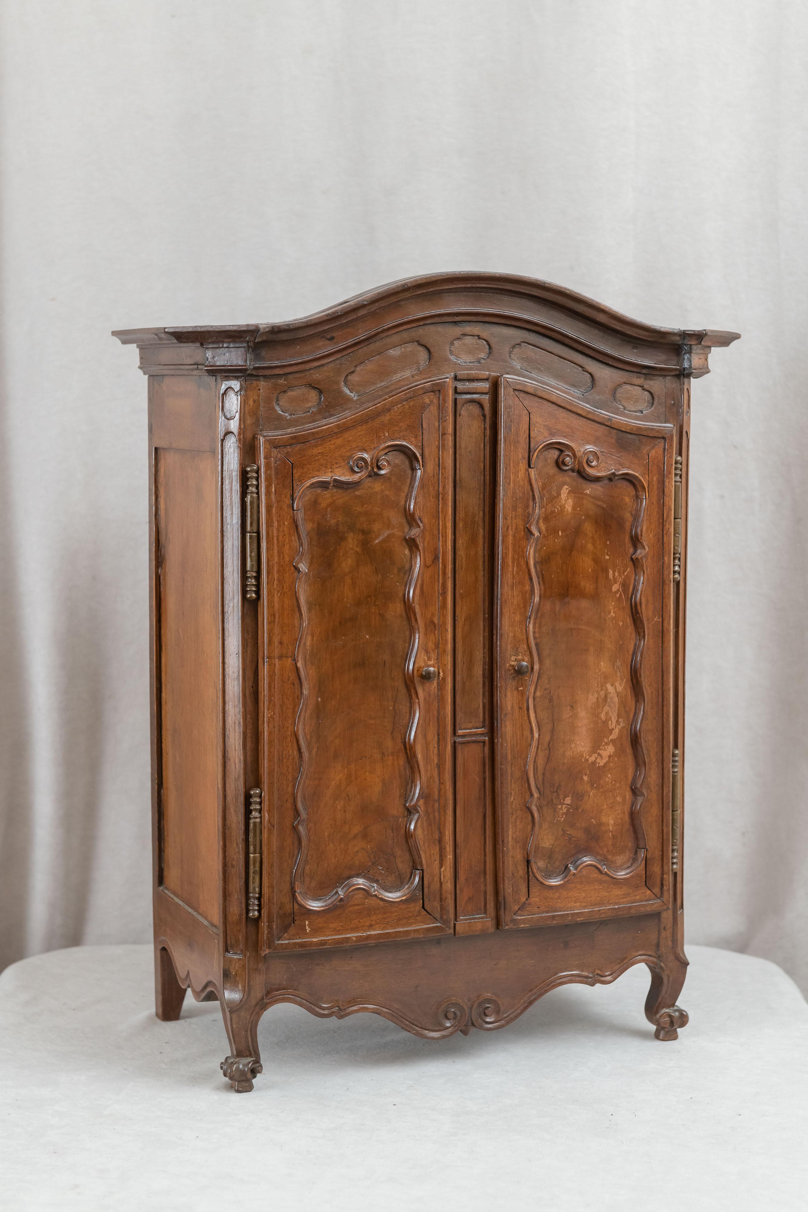 This most remarkable miniature walnut armoire has survived well over 100 years, and is still intact. We cannot say for sure whether it was a salesman's sample or just a miniature, but since it pays such close attention to all the necessary