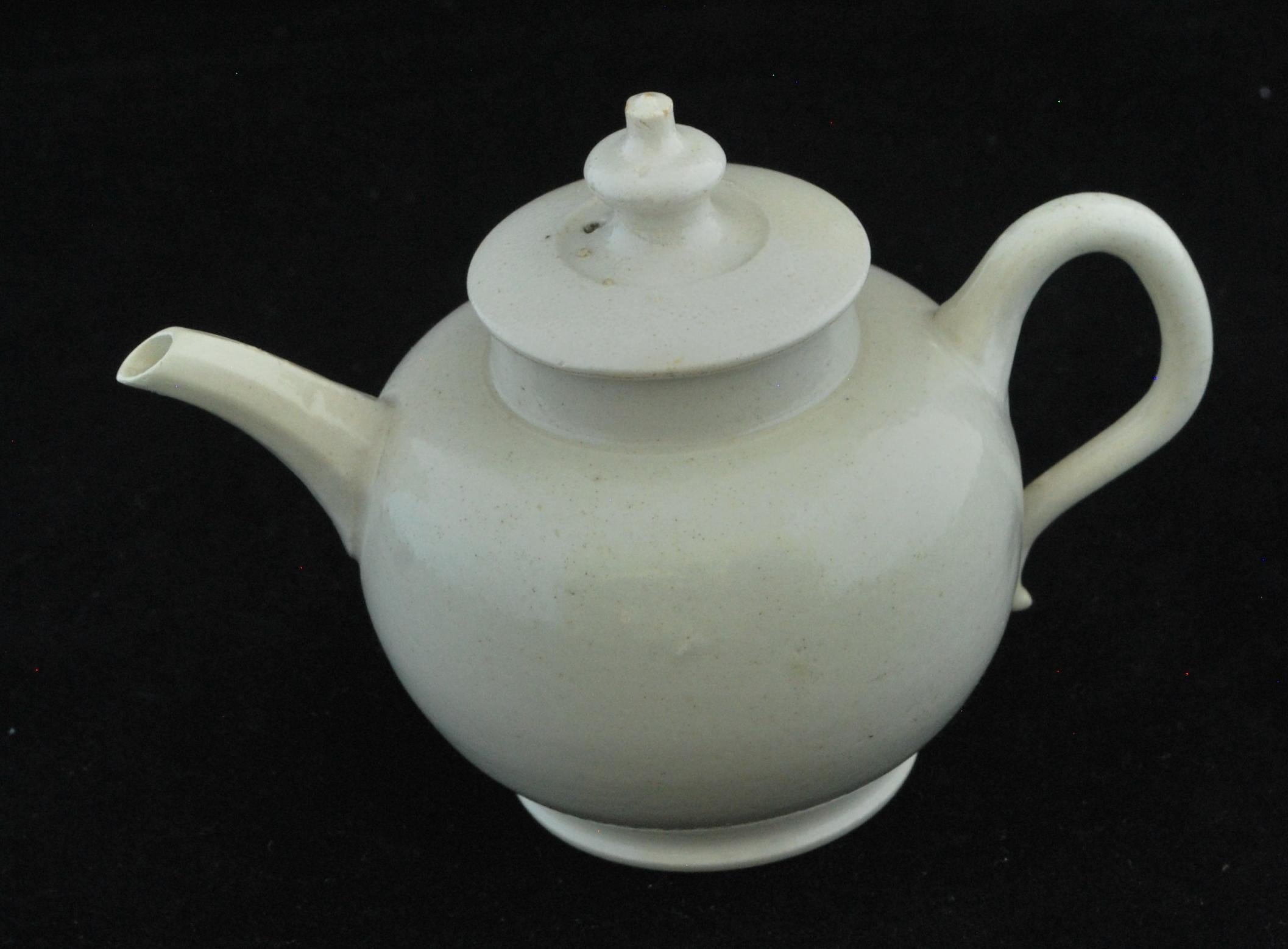 A fine, one-cup teapot in undecorated salt-glazed earthenware. The size reflects the early custom of a pot to each tea drinker.
   
