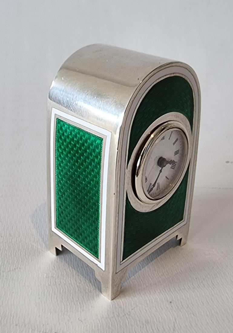An extremely fine miniature silver and green guilloche enamel carriage or travel clock in its original leather case. With a white enamel bordering the green guilloche enamel. 800 Silver mark, stamped on the back of the case Appay, Paris. Fine 8 day,