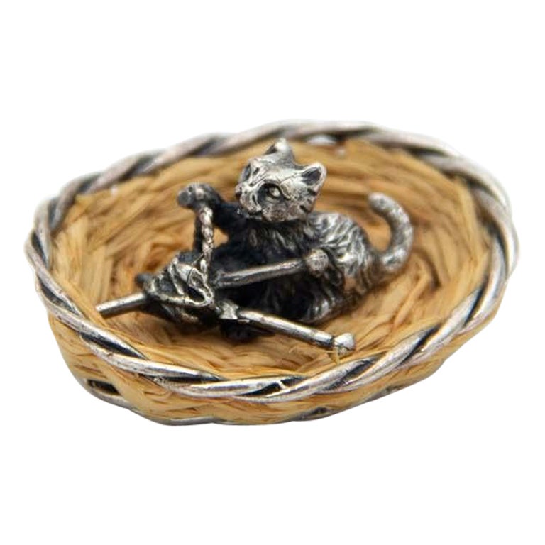 Miniature silver cat lying in a basket