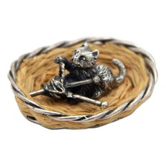 Miniature silver cat lying in a basket