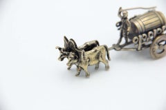 Miniature silver wagon pulled by oxen