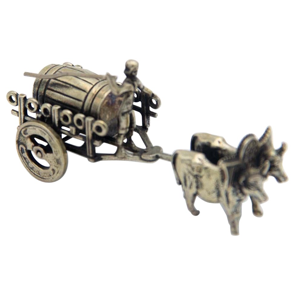 Miniature silver wagon pulled by oxen