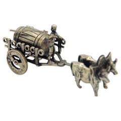 Miniature silver wagon pulled by oxen