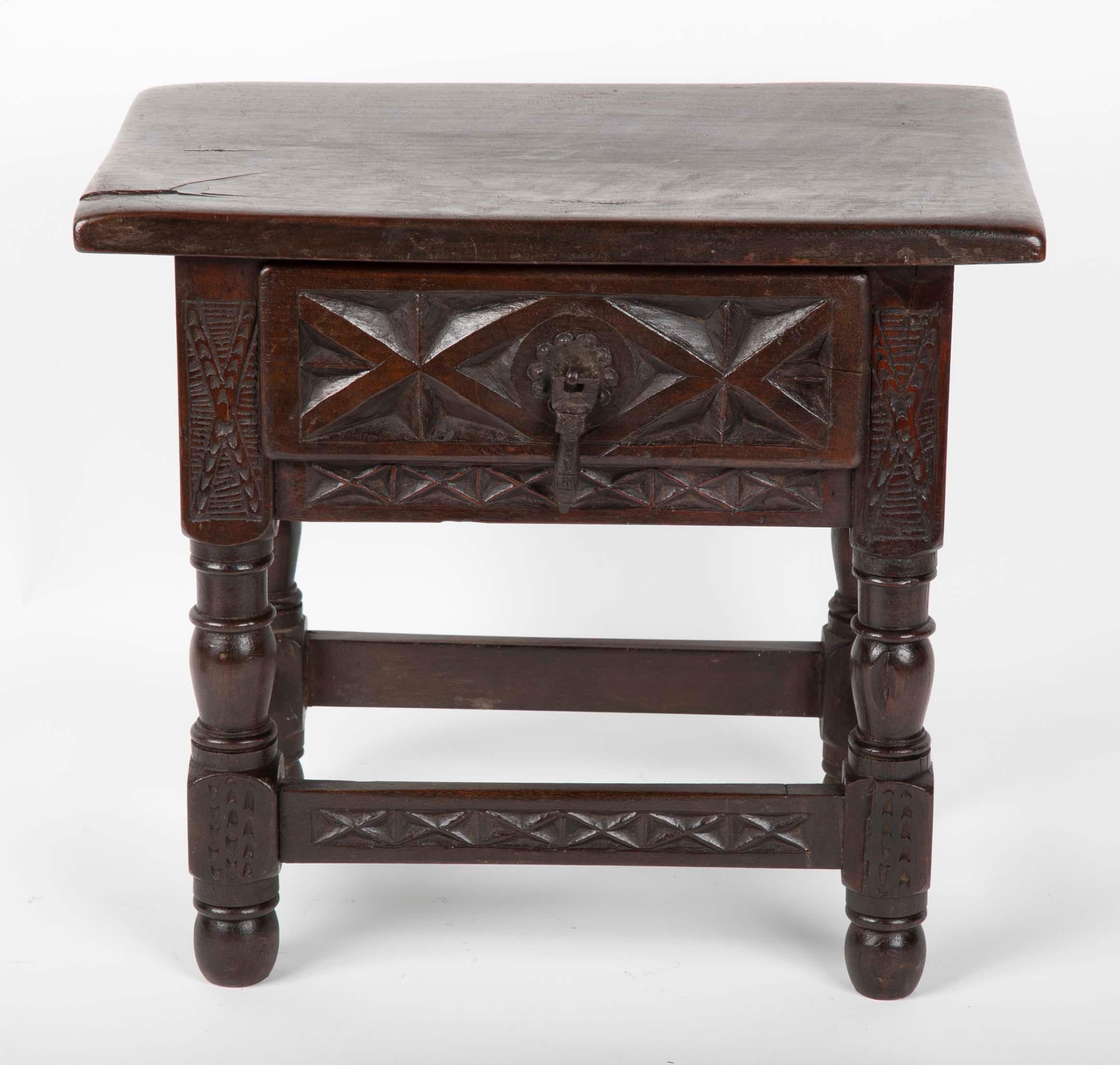 A thoroughly charming Spanish Baroque style table in miniature form. With geometric carved decoration and turned legs, and wrought iron tear-drop drawer pull. Possibly a model made by a cabinet as an example of what he could produce. It makes a
