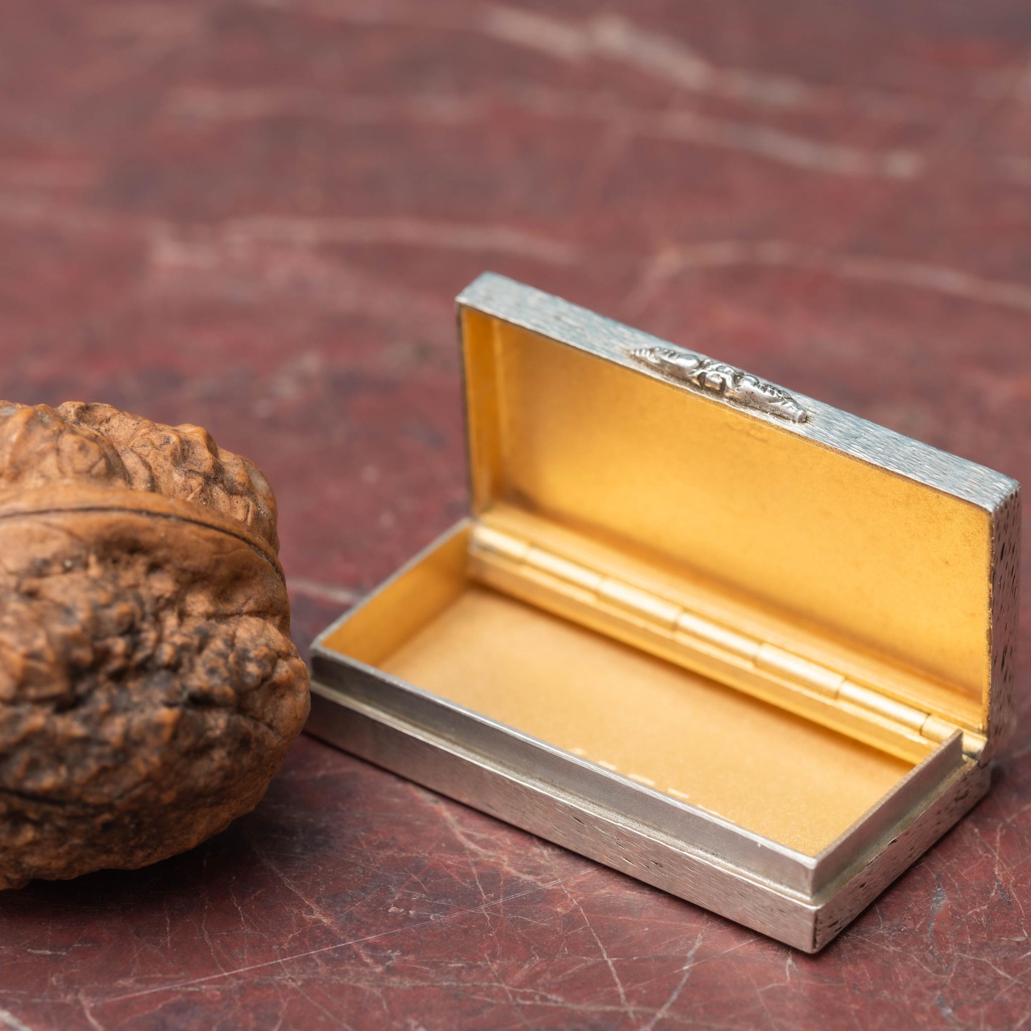 Fantastic miniature silver box with textured finish made from a decent gauge of sterling silver, by SJ Rose silversmiths. For use as a pill pot. Has gilded interior and is hallmarked Birmingham 1977. 

Dimensions: 5 cm/2 inches (length) x 2.5 cm/1