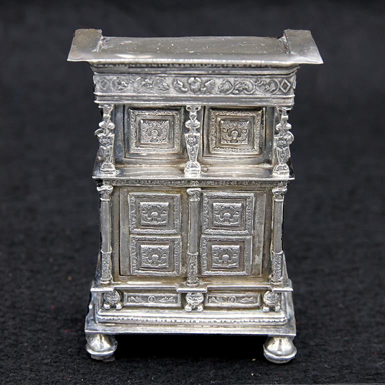 Probably made for an aristocratics child’s doll house or a copy of the Sterling Silver room furniture of King Louis XIII. Has a chandelier, and opening doors to the Buffets.