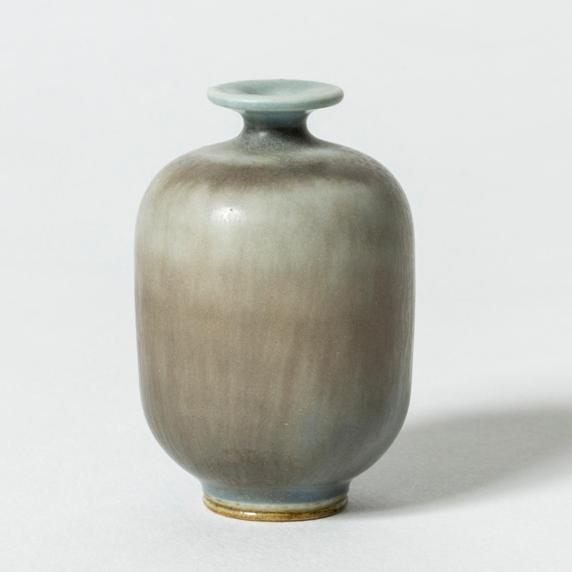 Miniature stoneware vase by Berndt Friberg, in a plump design. Pale blue hare’s fur glaze blended with brown streaks.