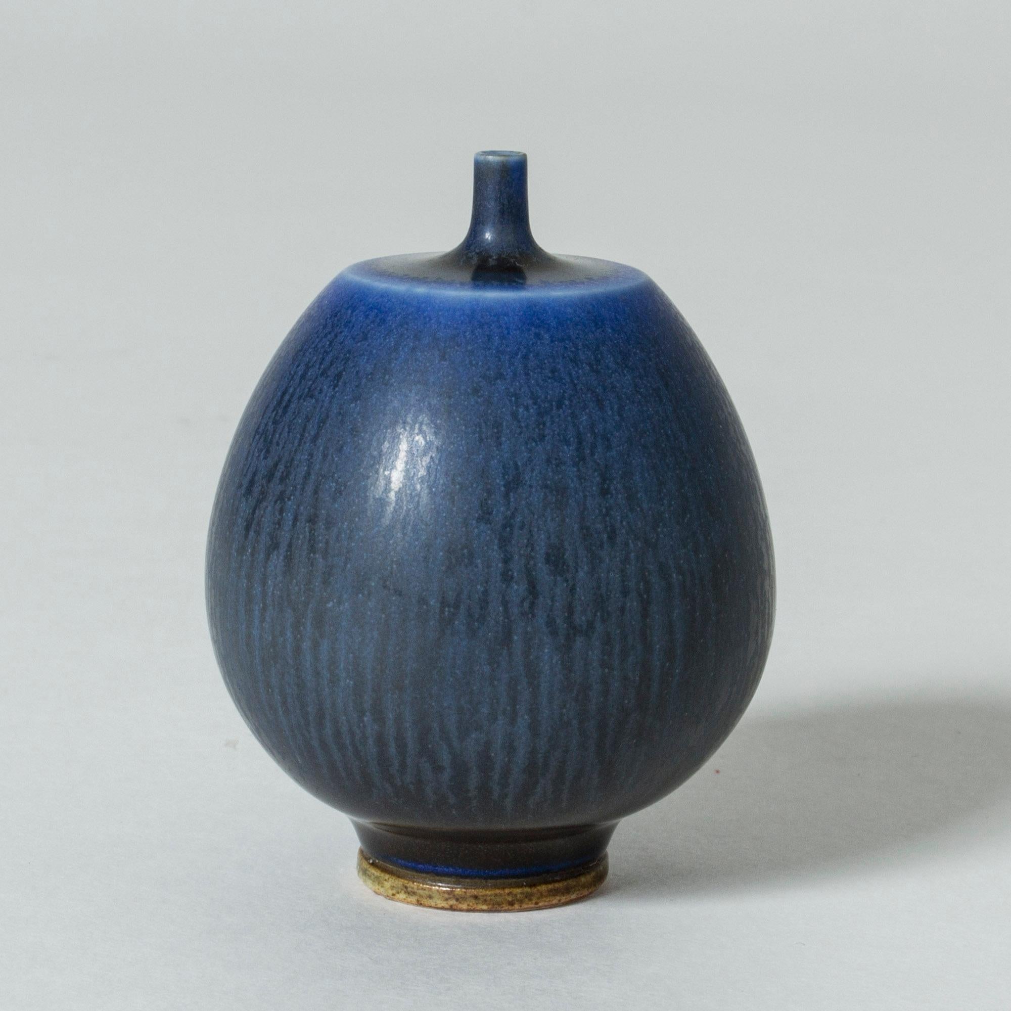 Lovely miniature stoneware vase by Berndt Friberg, with a edgy transition from the oval body to the thin neck. Intense dark blue hare’s fur glaze.