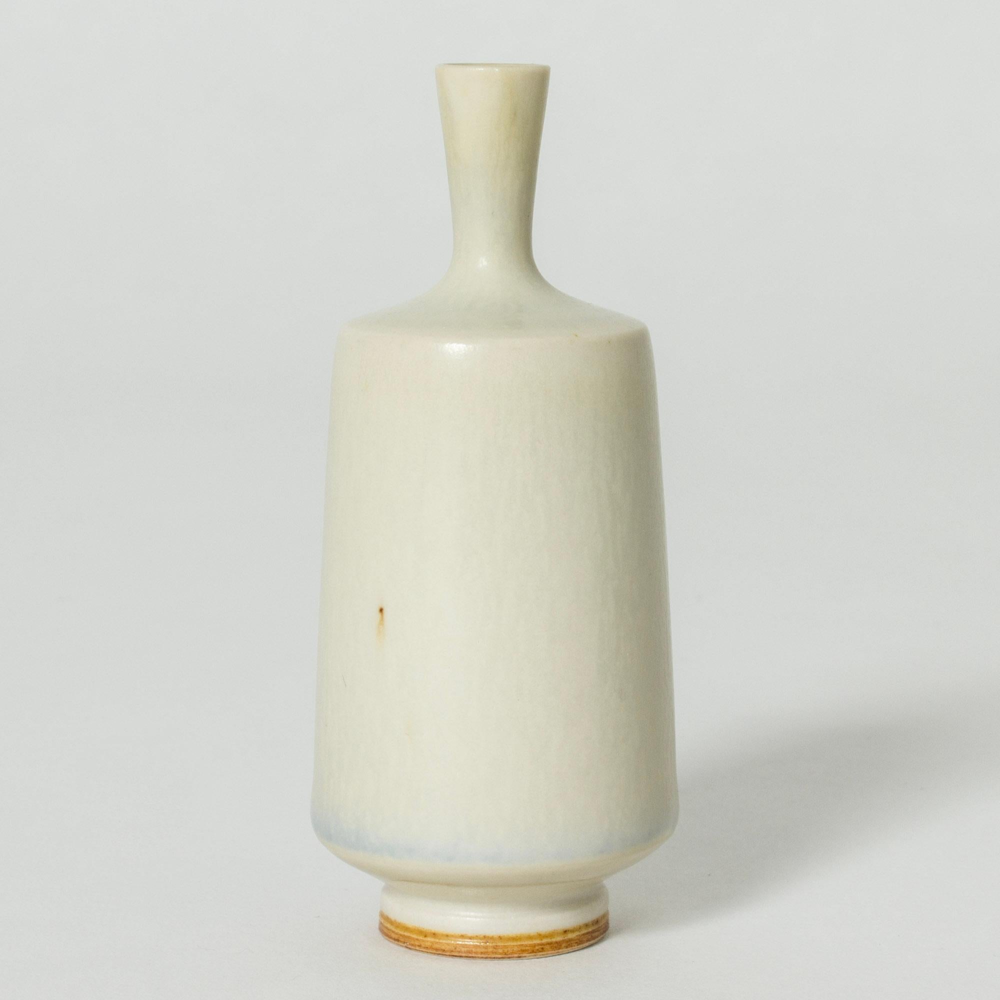 Minature stoneware vase by Berndt Friberg, in a clean cylinder form, with white hare’s fur glaze. White vases by Friberg are particularly rare and sought after.

Berndt Friberg was a Swedish ceramicist, renowned for his stoneware vases and vessels