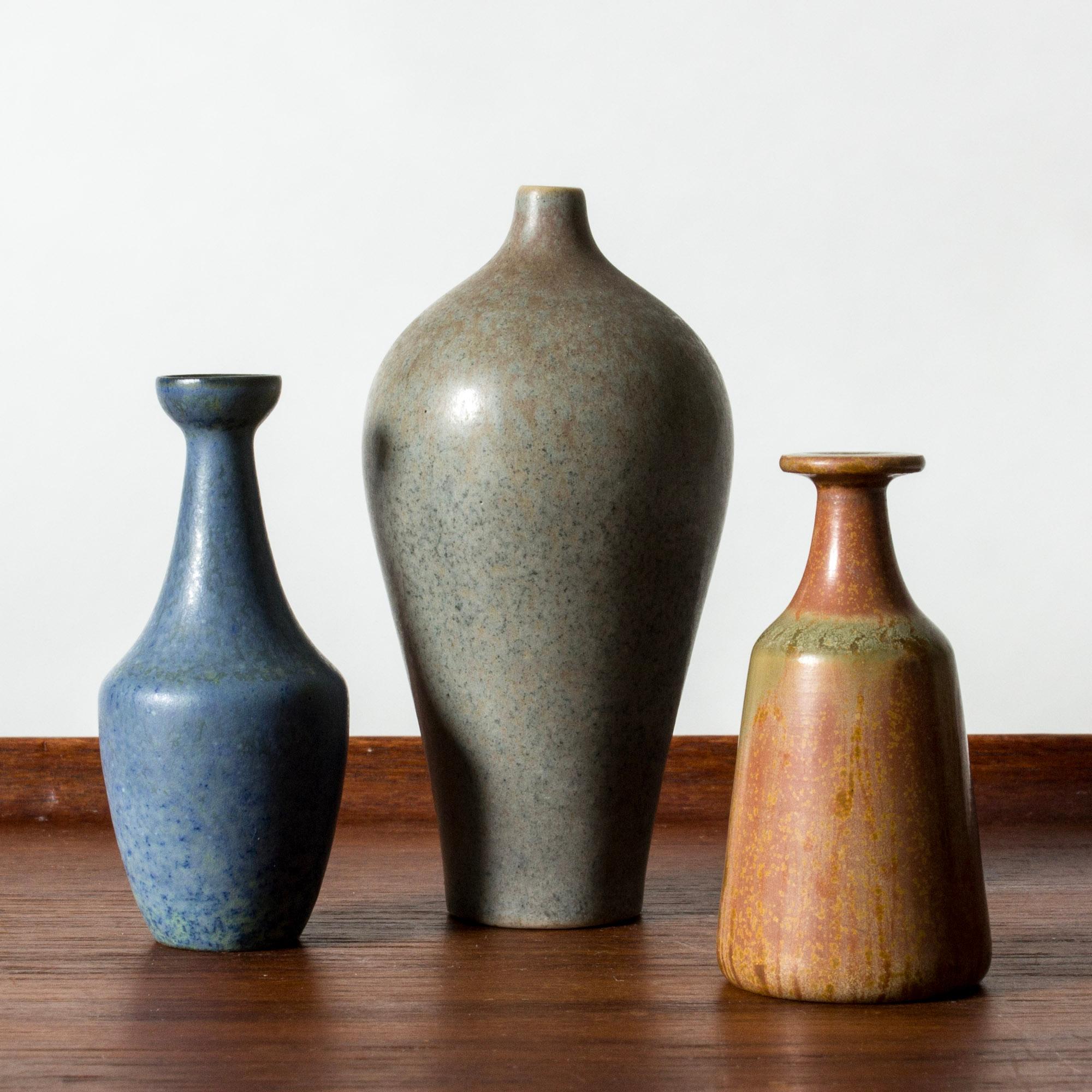 Set of three miniature stoneware vases by Gunnar Nylund, in imaginative forms with rounded lines. Lovely glazes in nuances of terracotta, blue and steel grey.

Height 6/6.7/9 cm, Diameter 3-4.5 cm.

Gunnar Nylund was one of the most influential