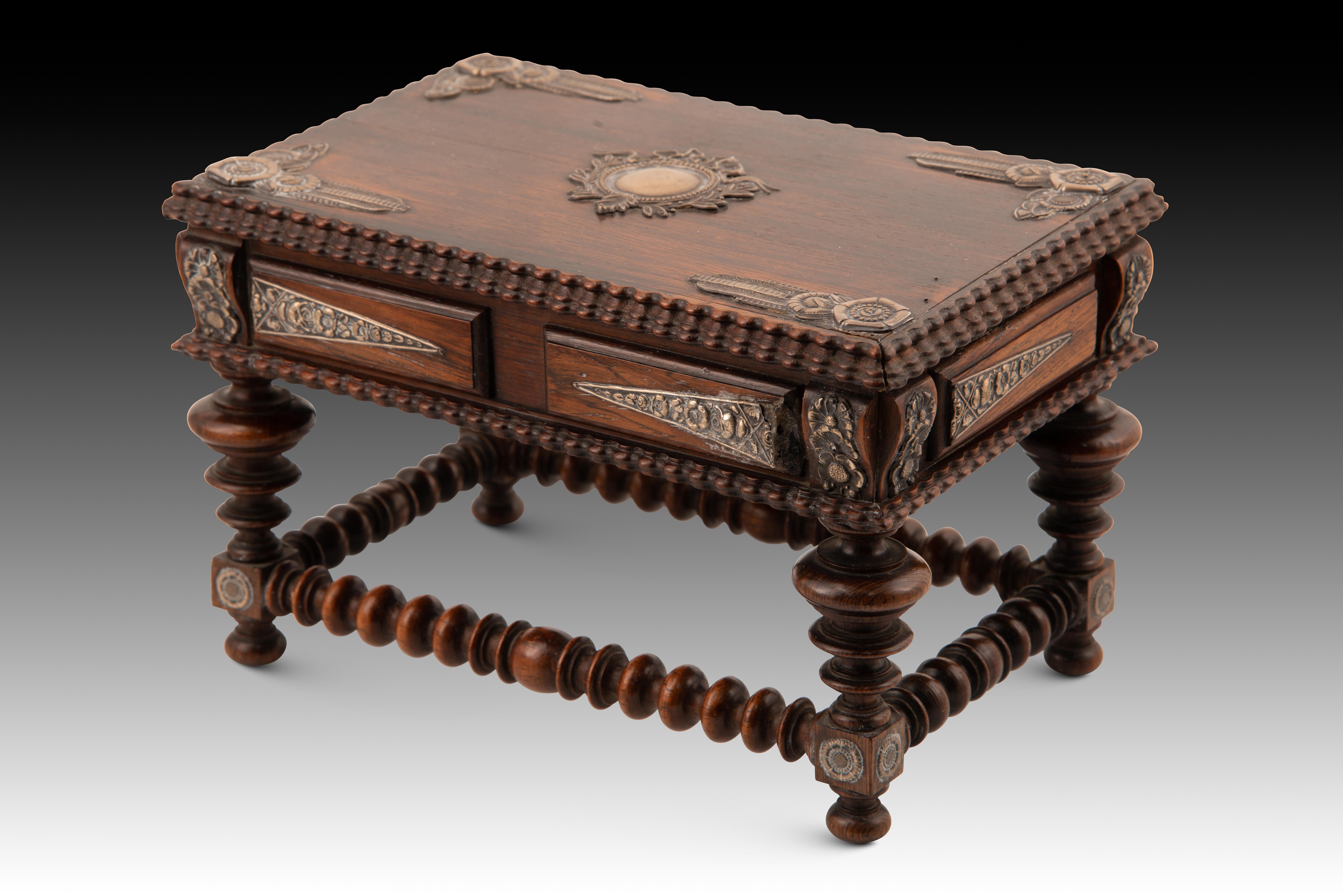  Miniature table. Wood, silver. Pinto & Carvalho, Portugal, first half of the 20th century.
 It has defects. 
 Mark on the inside of the lid. Miniature Portuguese style table made of carved and turned wood that has legs with discs secured with