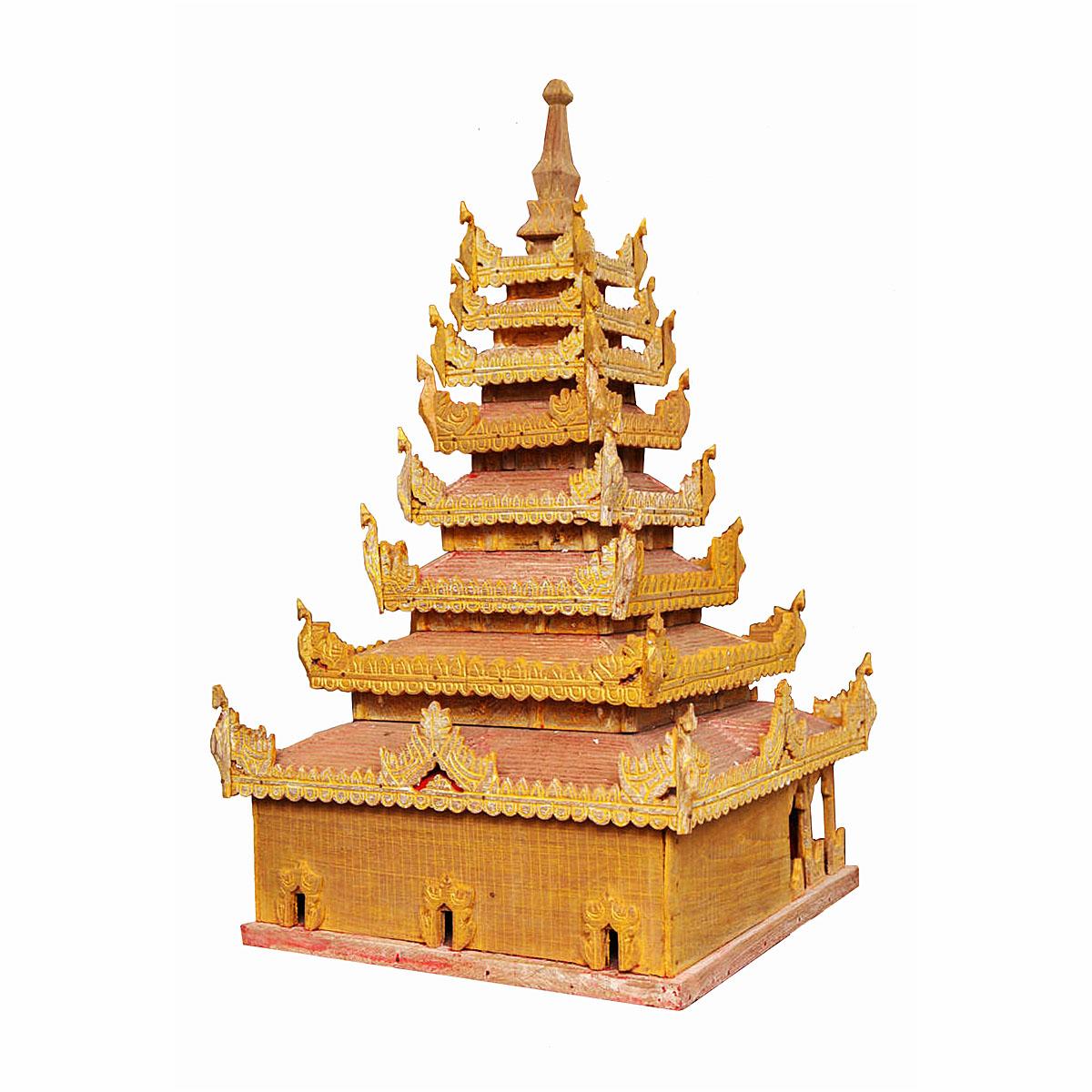 A hand-crafted miniature Buddhist temple in wood, polychromed in gold and red, with finely carved details. Burma (Myanmar), early 20th Century. 

The model consists of six detachable pieces, each one of solid and heavy wood, finely carved to