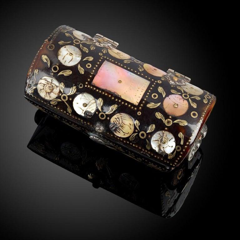 A miniature tortoiseshell casket in the shape of a cassone, silver feet and mounts; delicately decorated with brass and mother of pearl pique work; Spanish or Spanish Colonial, circa 1650.