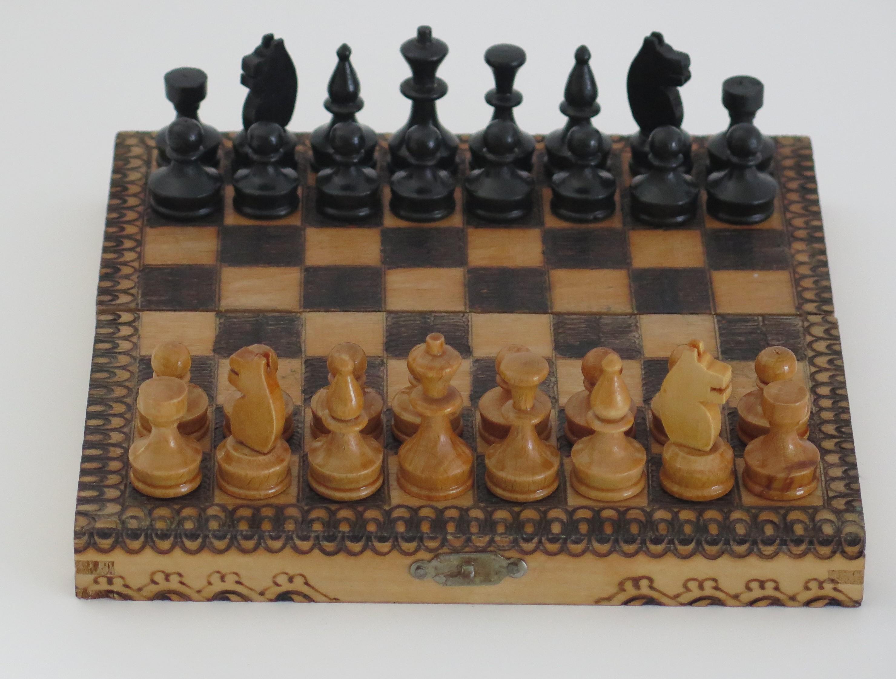 This is a high quality handmade Miniature or travelling wood chess set game of 32 pieces in its own lidded pokerwork decorated box, which we date to the English Edwardian period, circa 1900.

This piece is all handmade. The chess set is complete