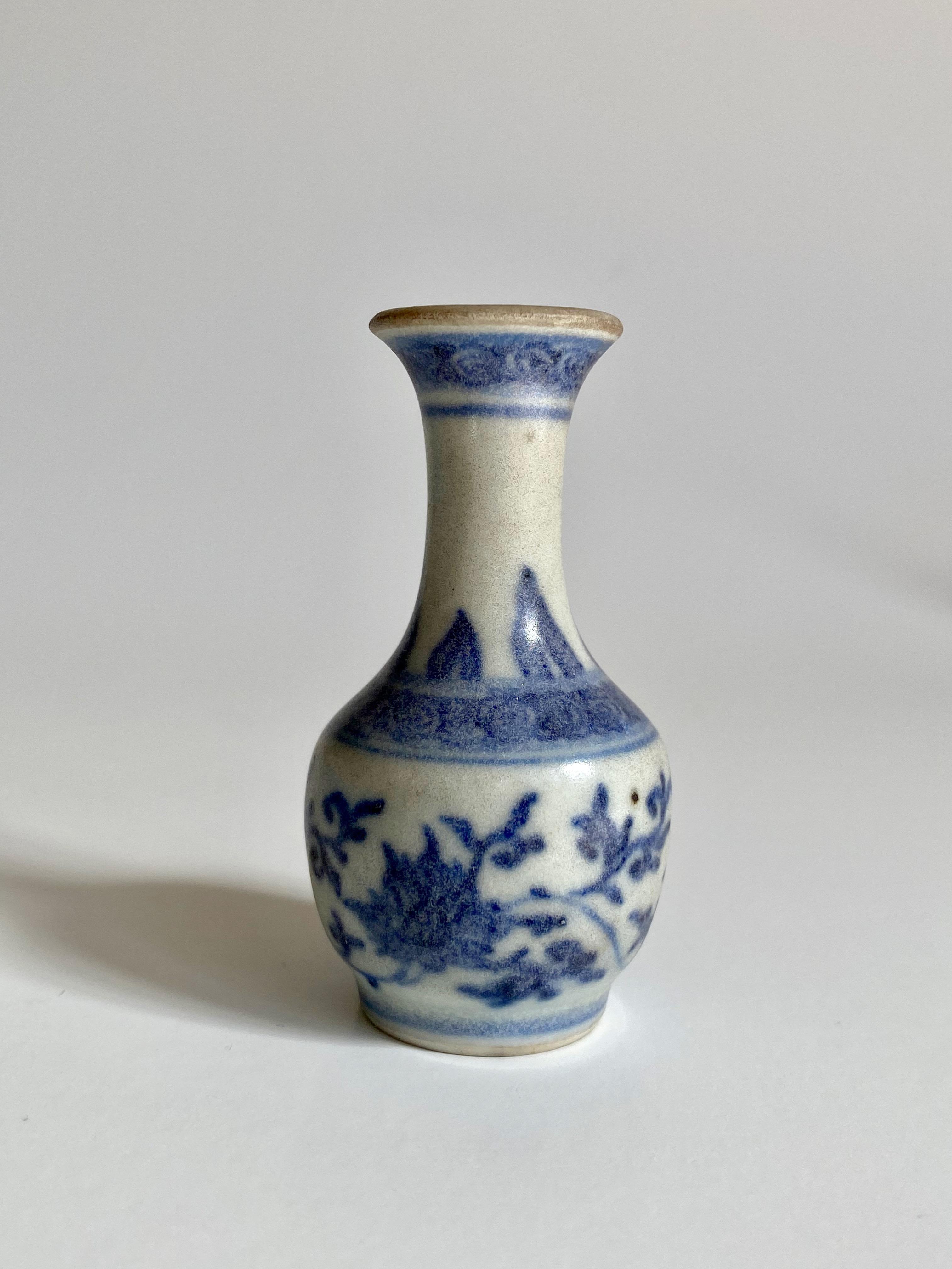 Miniature 17th century blue and white vase with a flared rim and three bands of decoration 
 
This miniature vase was part of a hoard recovered by Captain Michael Hatcher from the wreck of a ship that sunk in the South China sea in approximately
