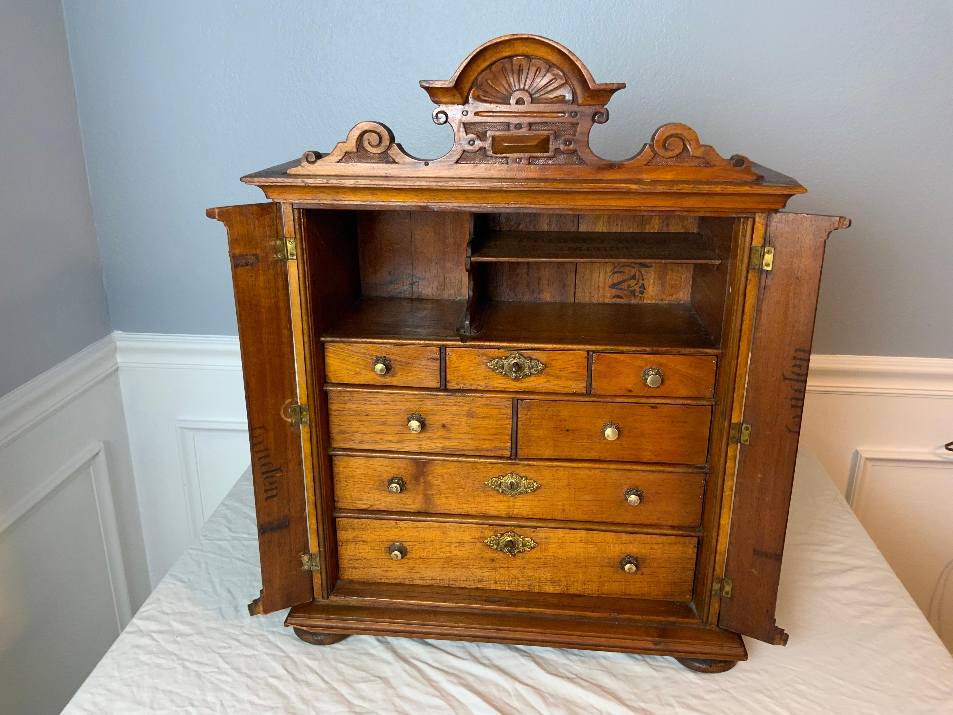 A very unique Victorian era hand made miniature chest that resembles a larger Victorian lock side chest with the two small pieces on the side that flip open to access the drawers. There is a original hook on the back for hanging it if required. This