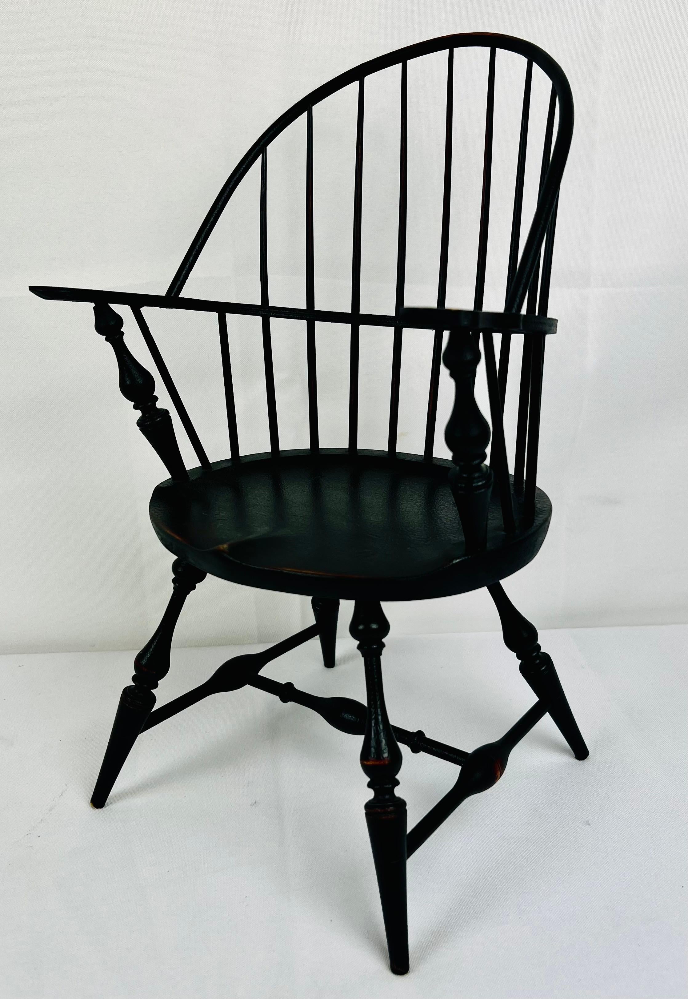 Miniature Windsor armchair painted essex green.  Stamped on the underside Riverbend Chair co.,  Westchester, Ohio.  Very gracefully
styled with turned arm supports, legs and stretchers.
H-13”
W-8.25”
D-6.75”
Seat Ht-5.5”
Seat D-5.75