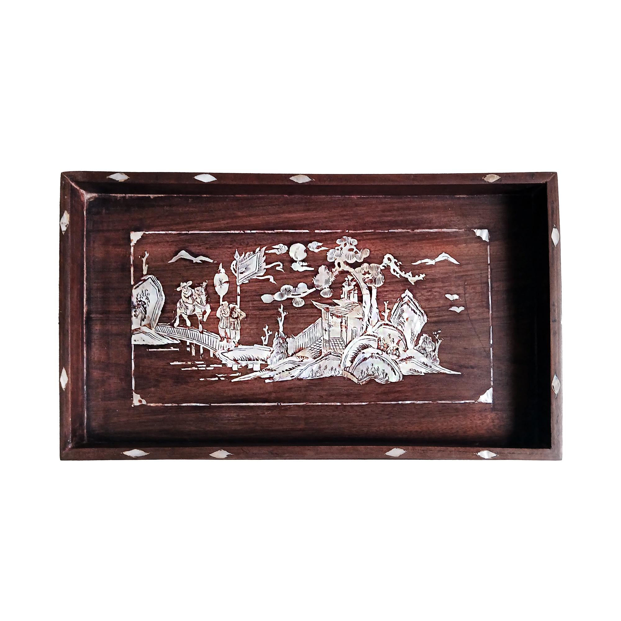 A small Chinese tray, hand-crafted in teak with mother-of-pearl inlays, early 20th Century.  

Rustic teak in a dark brown/red semi-gloss finish. Four stretchers connect the turned legs. Delicate mother-of-pearl inlaid decorations throughout, with