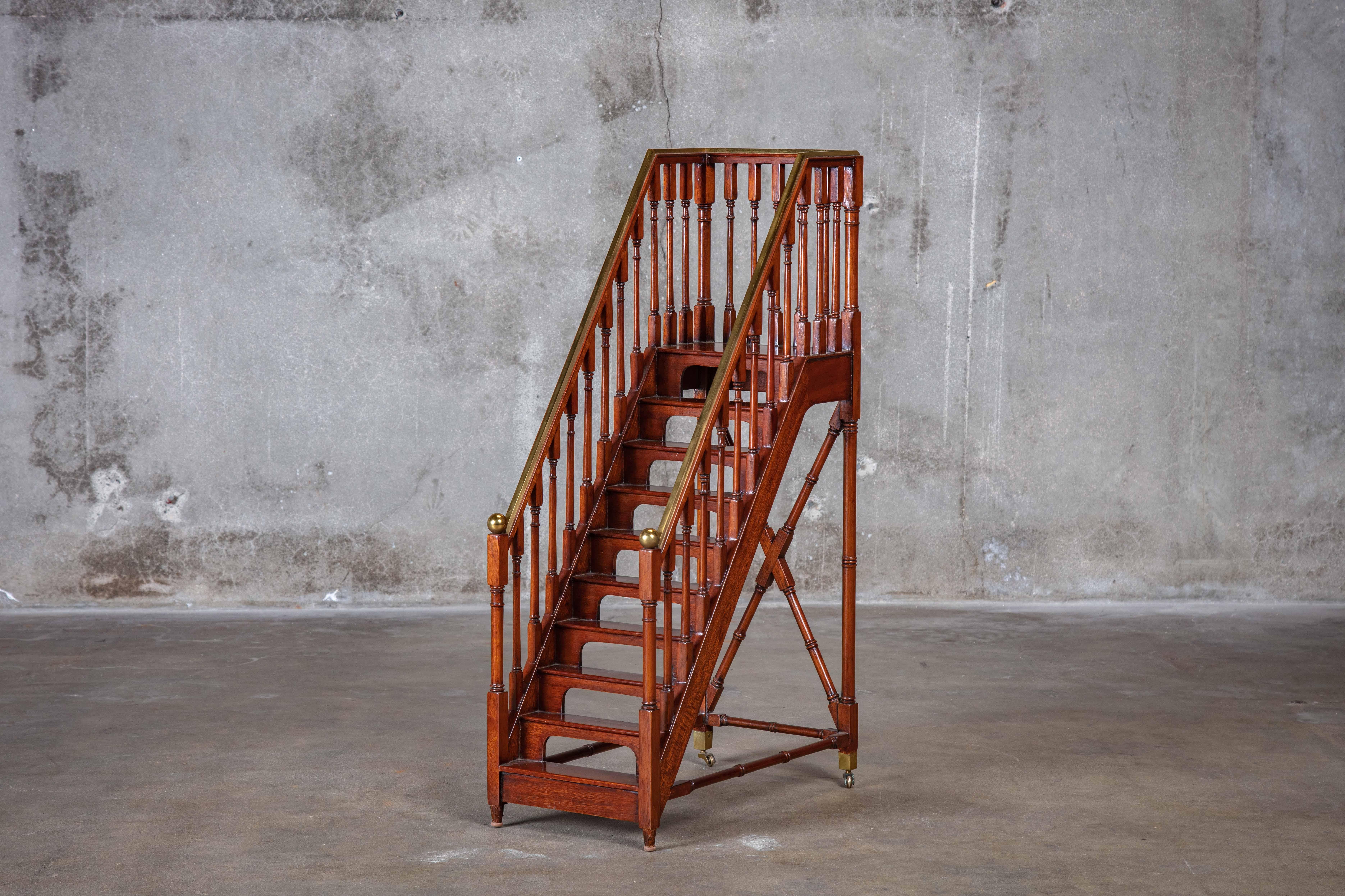 Miniature wood staircase with brass accents.