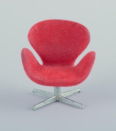 Miniatures of the "Swan" chair and sofa in red fabric, designed by Arne Jacobsen