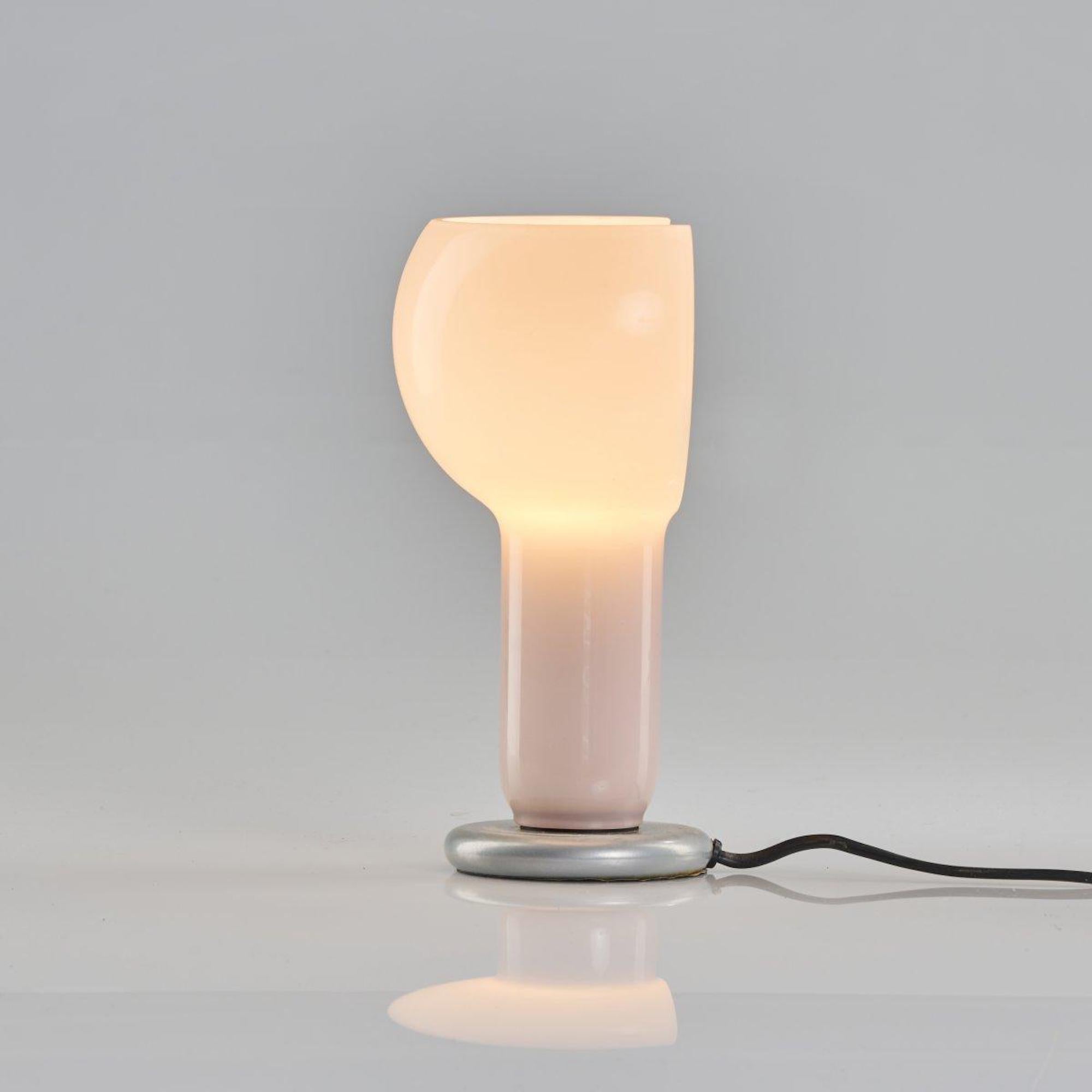 Miniflash table light realized by Joe Colombo in 1968.

H. 20.5 cm. Made by Oluce, Milan.

Glass, pink and white, cast metal, painted grey. Marked: manufacturer's label.

Ref. Gramigna, Repertorio 1950 - 1980, Milan 2001, p. 190; Kries/ Favata, Joe