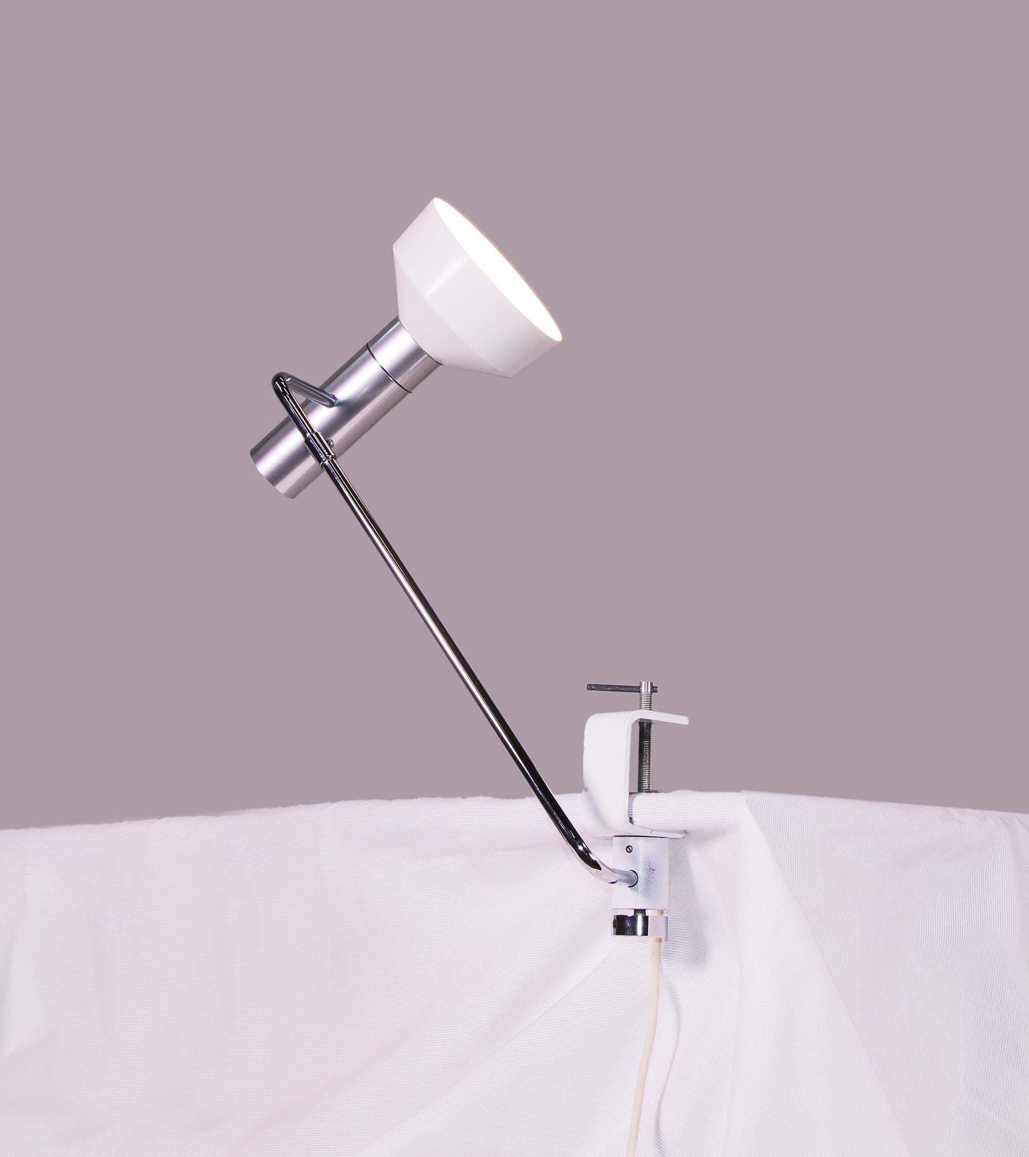 A Minilux clamp lamp designed by Rico & Rosemarie Baltensweiler in the 1950s and manufactured by Baltenweiler, Switzerland. This lamp is made of aluminium and chrome with an adjustable arm and reflector. 

Measures: height: 18“ in. (46 cm), height