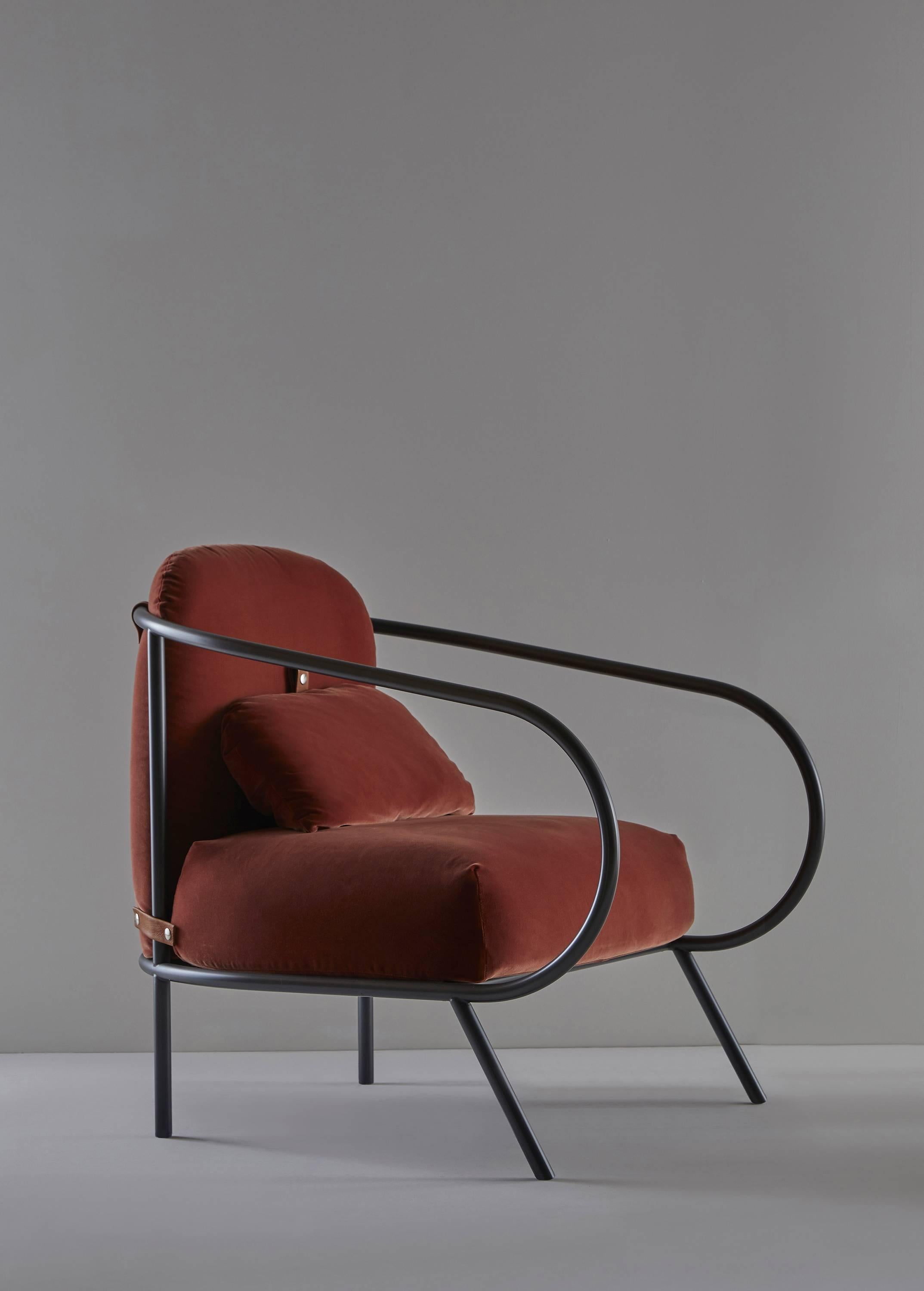 Minima armchair in red by Denis Guidone for Mingardo is the first armchair in the Mingardo catalog and is the first time that the company has released a padded chair. The armchair rests on the ground through the unique added elements that stronger