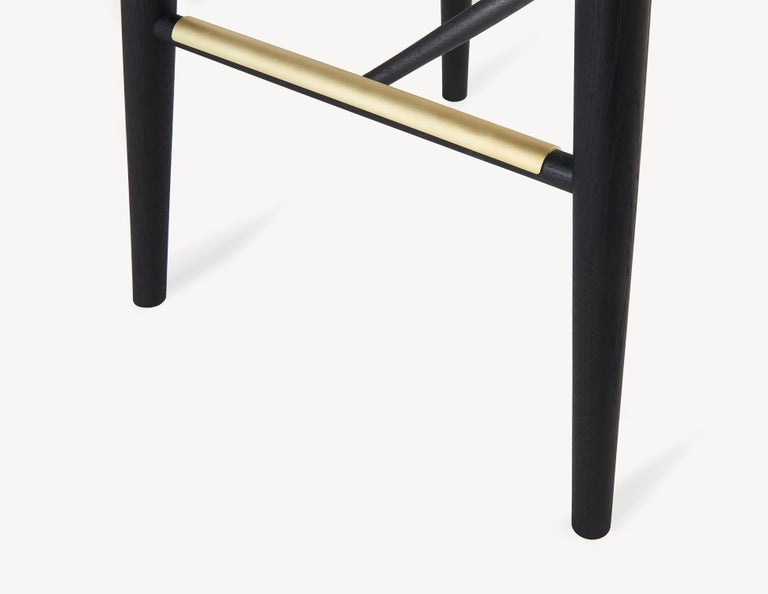 Scandinavian Modern Minimal Black Bar Stool with Brass Foot Rests by Coolican & Company For Sale