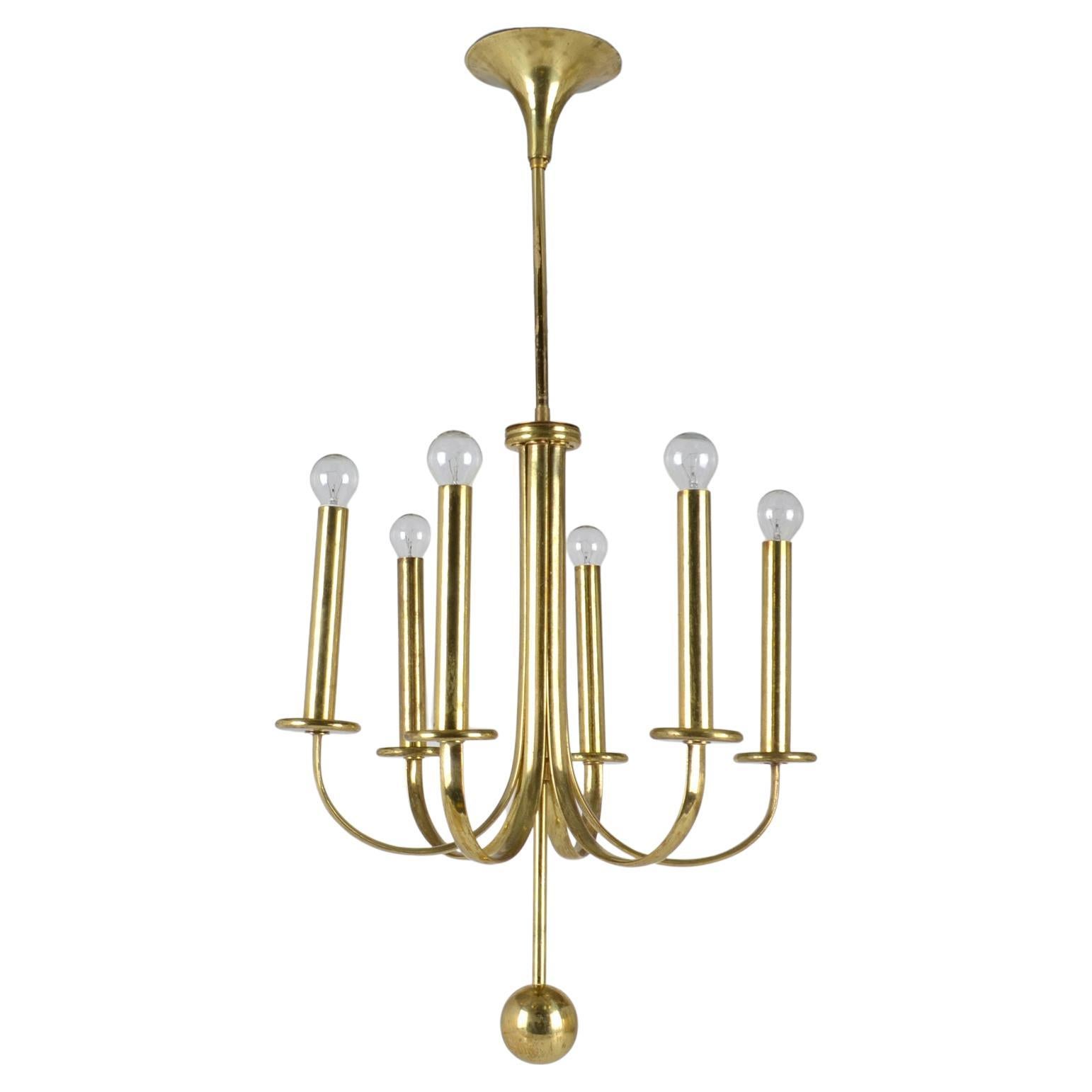 Elegant brass six arm chandelier with minimal contours and original patina.