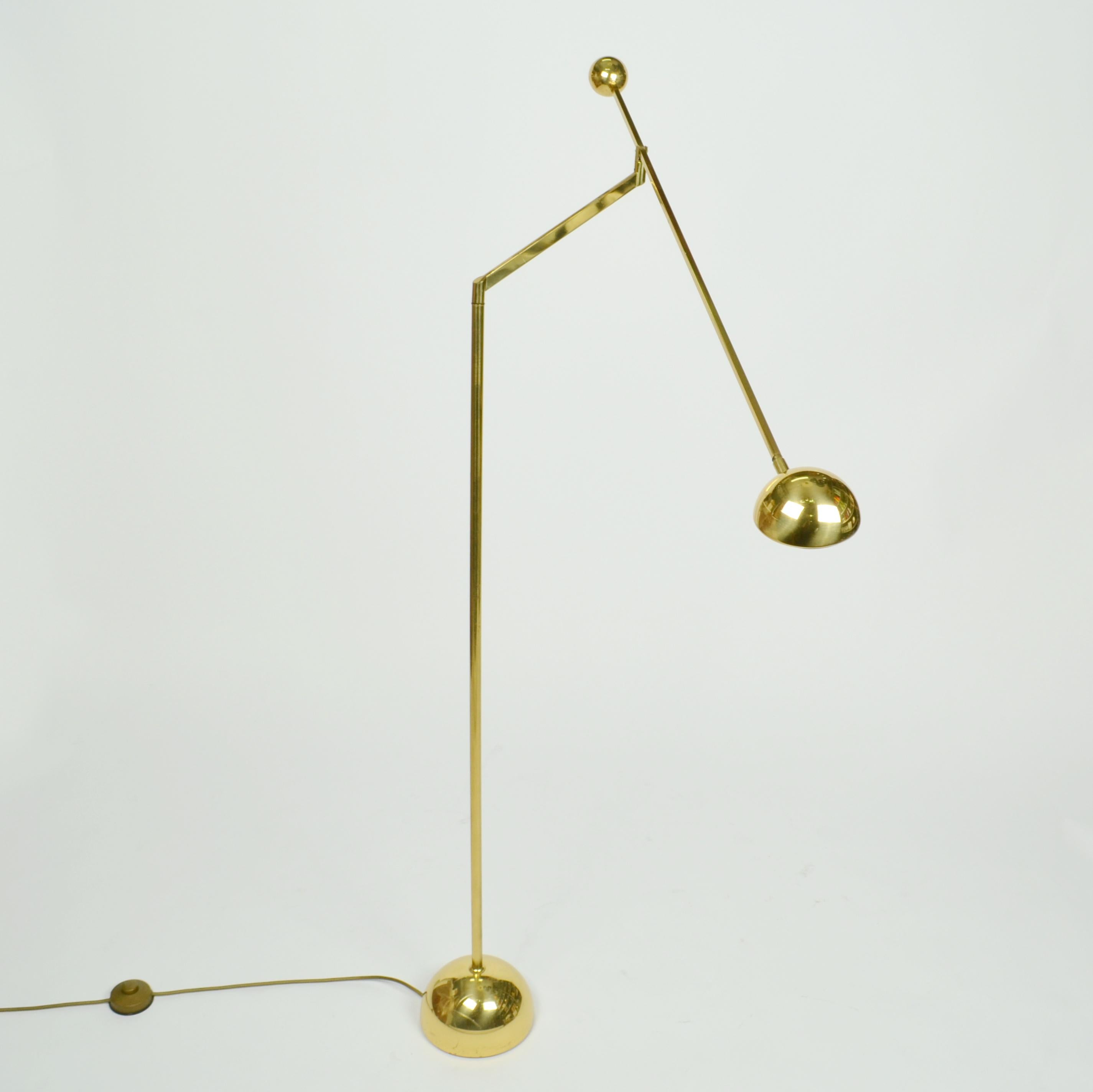 Minimalist counterbalance floor lamp is super flexible, with an arm adjustable to almost 180 degrees. The halogen light source is attached to a long arm holding a spherical counter weight. The arm sits on an angled stand with counter balance which