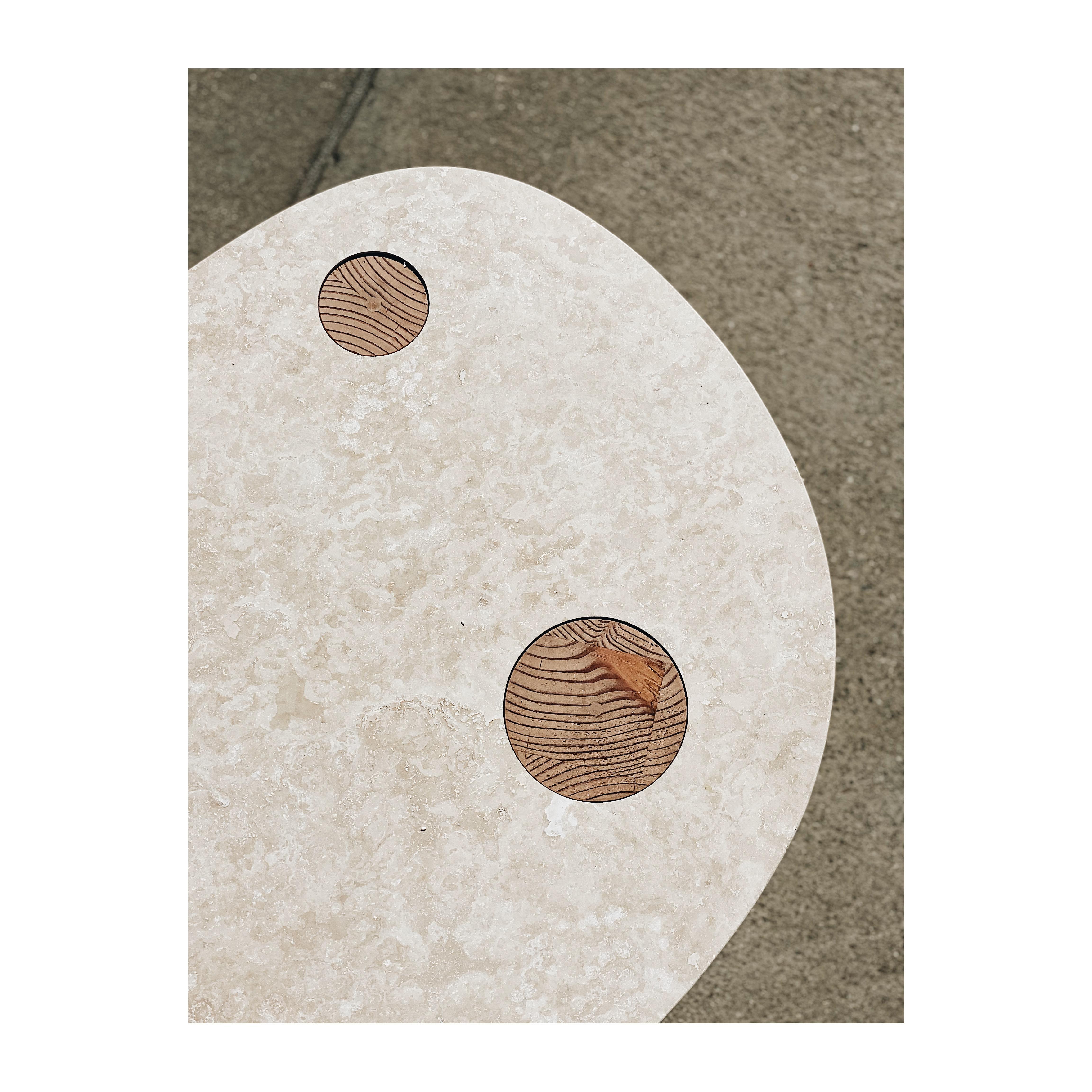 The coffee table focuses on the simplicity and engagement of two complimentary materials - travertine slab and solid wood. Solid stumps of Douglas Fir are turned by hand by our wood craftsmen and fitted perfectly into a machine cut openings on the