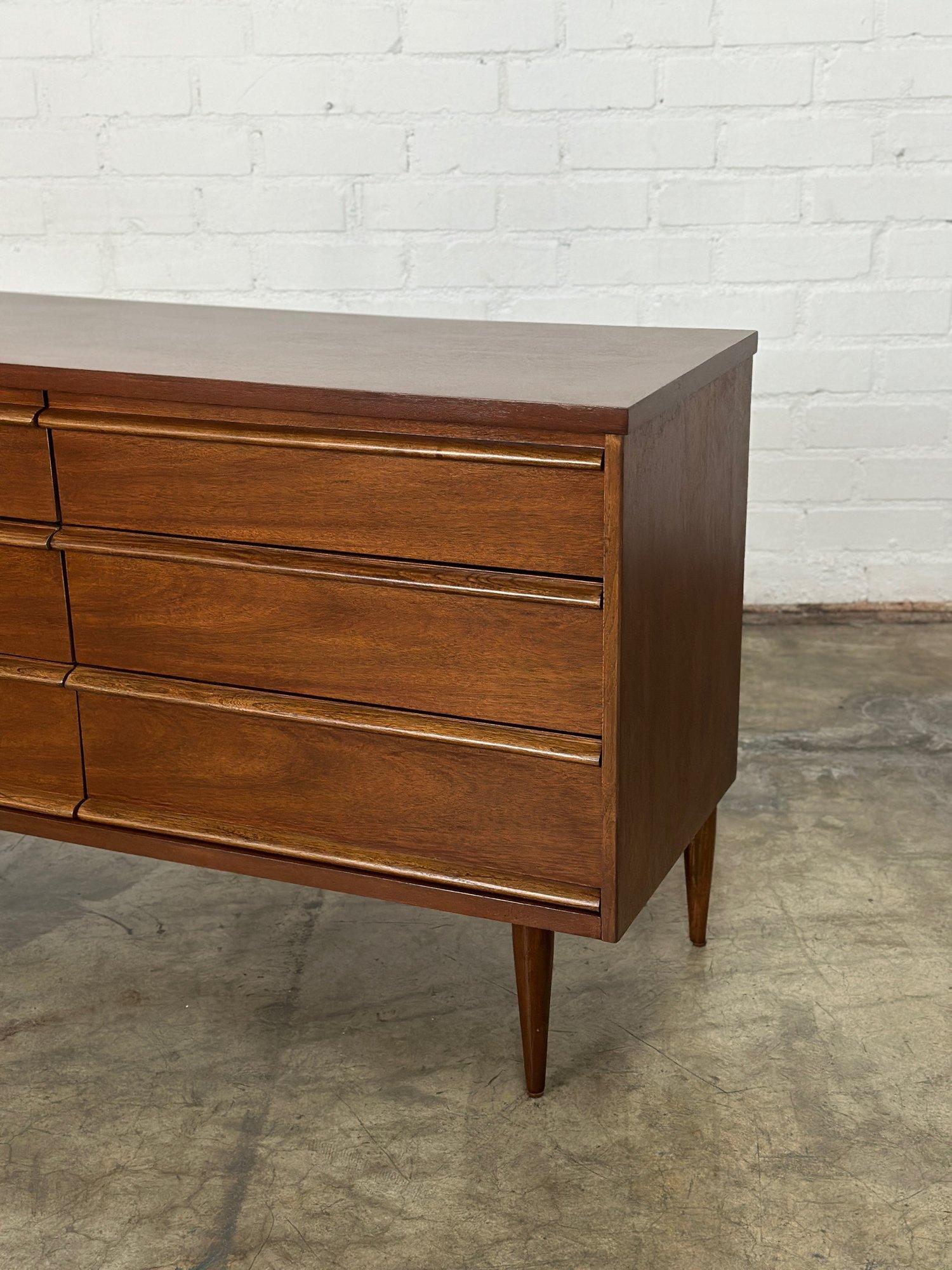 W52 D18 H30.5

Fully restored vintage dresser by Bassett. Item is structurally sound and sturdy with no major areas of wear. Dresser features sculpted solid wooden handles and manufacture stamp is well preserved. Drawers are clean and slide smoothly