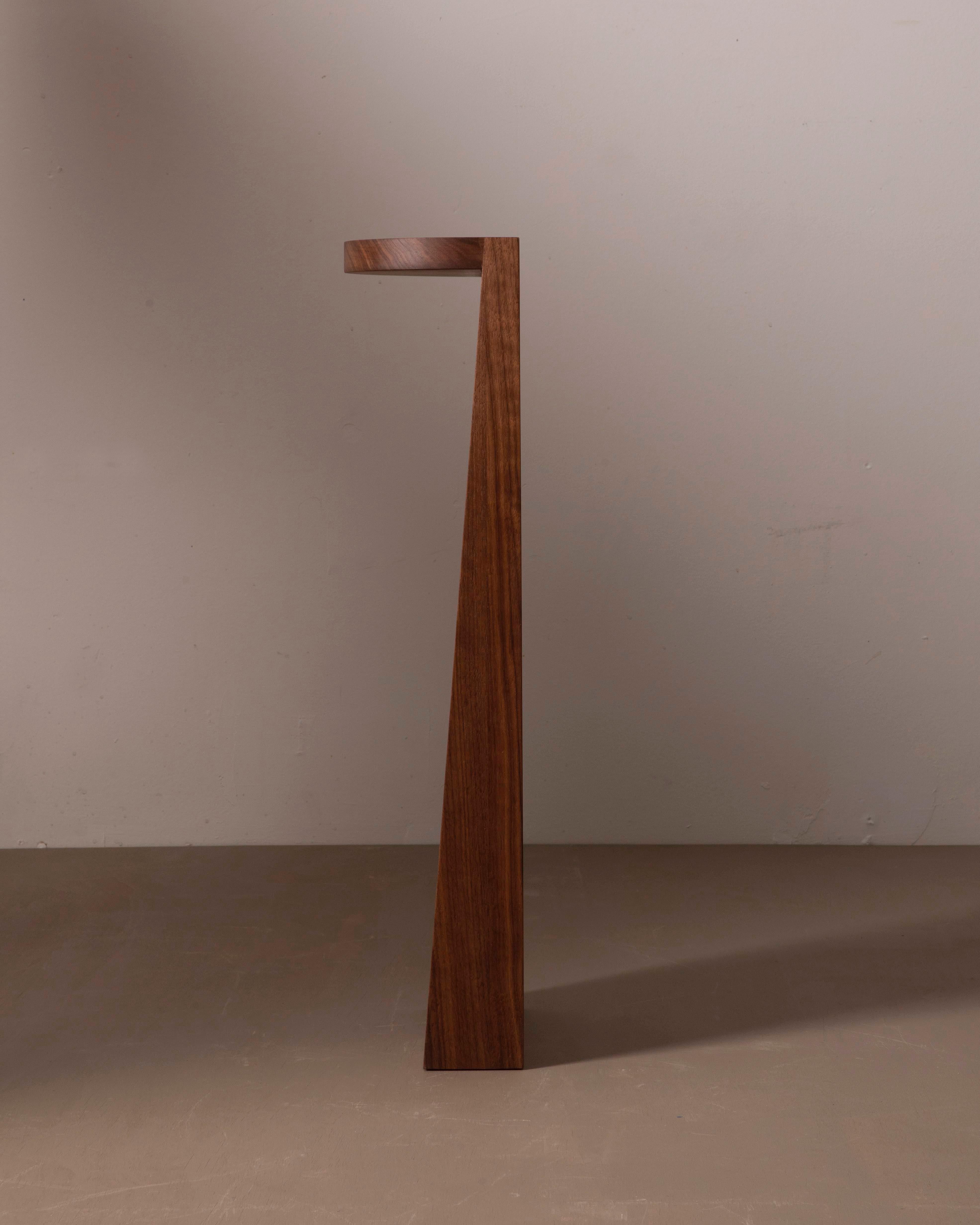 A simple wooden half circle and elongated wedge. The perfect pedestal for precious artifacts. Works as a nightstand, end table or plant stand. 

Counterweighted with hidden steel in the base that provides balance on smooth surfaces. 

This